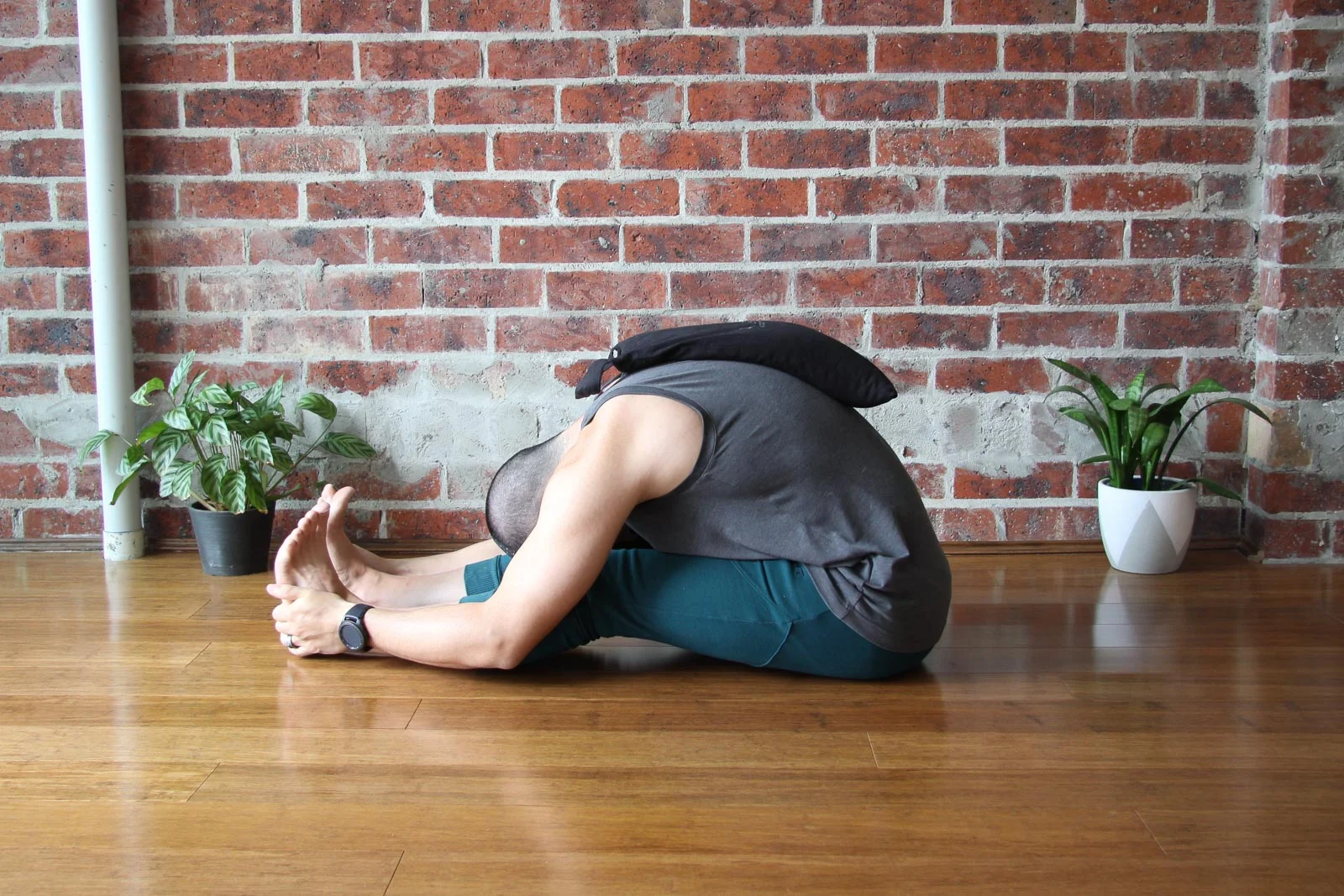 Paschimottanasana , with sandbag on spine