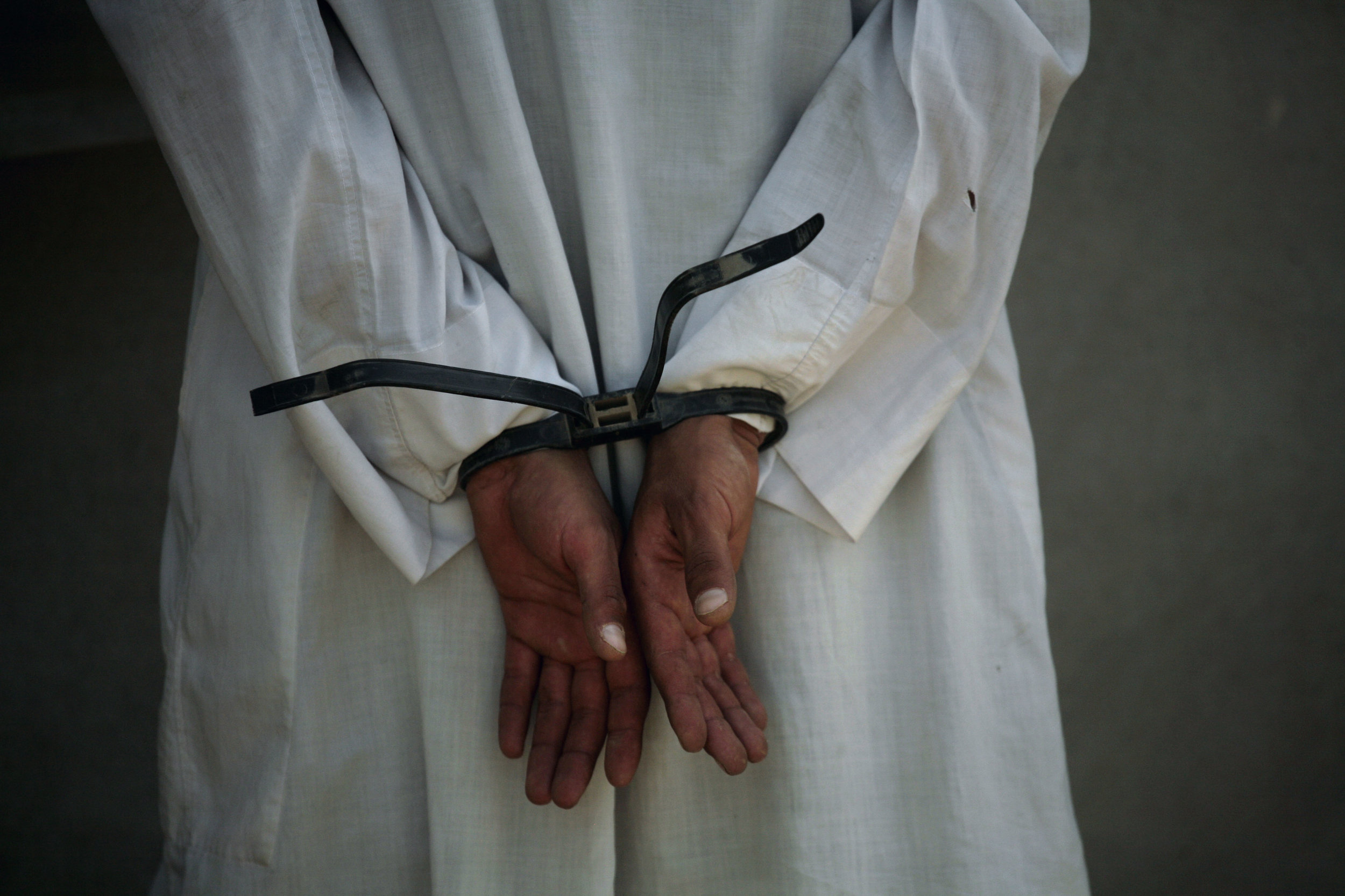 An Iraqi man is detained by U.S. and Iraqi security forces after they rescued 50 kidnapped university students in Mosul on April 6, 2008. 