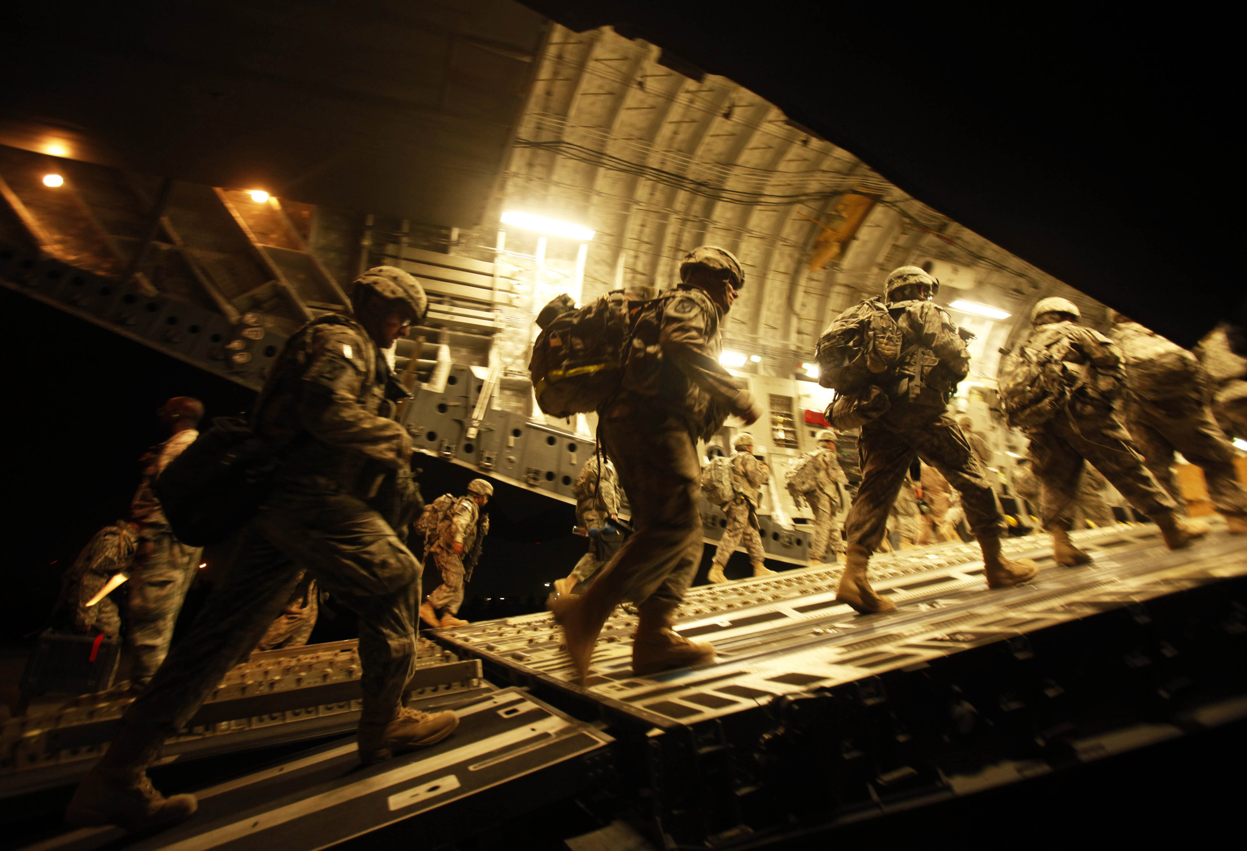 U.S. soldiers board a C-17 aircraft at Baghdad International Airport as they begin their journey to the United States on July 13, 2010. This was the beginning of a phased withdrawal from the country.