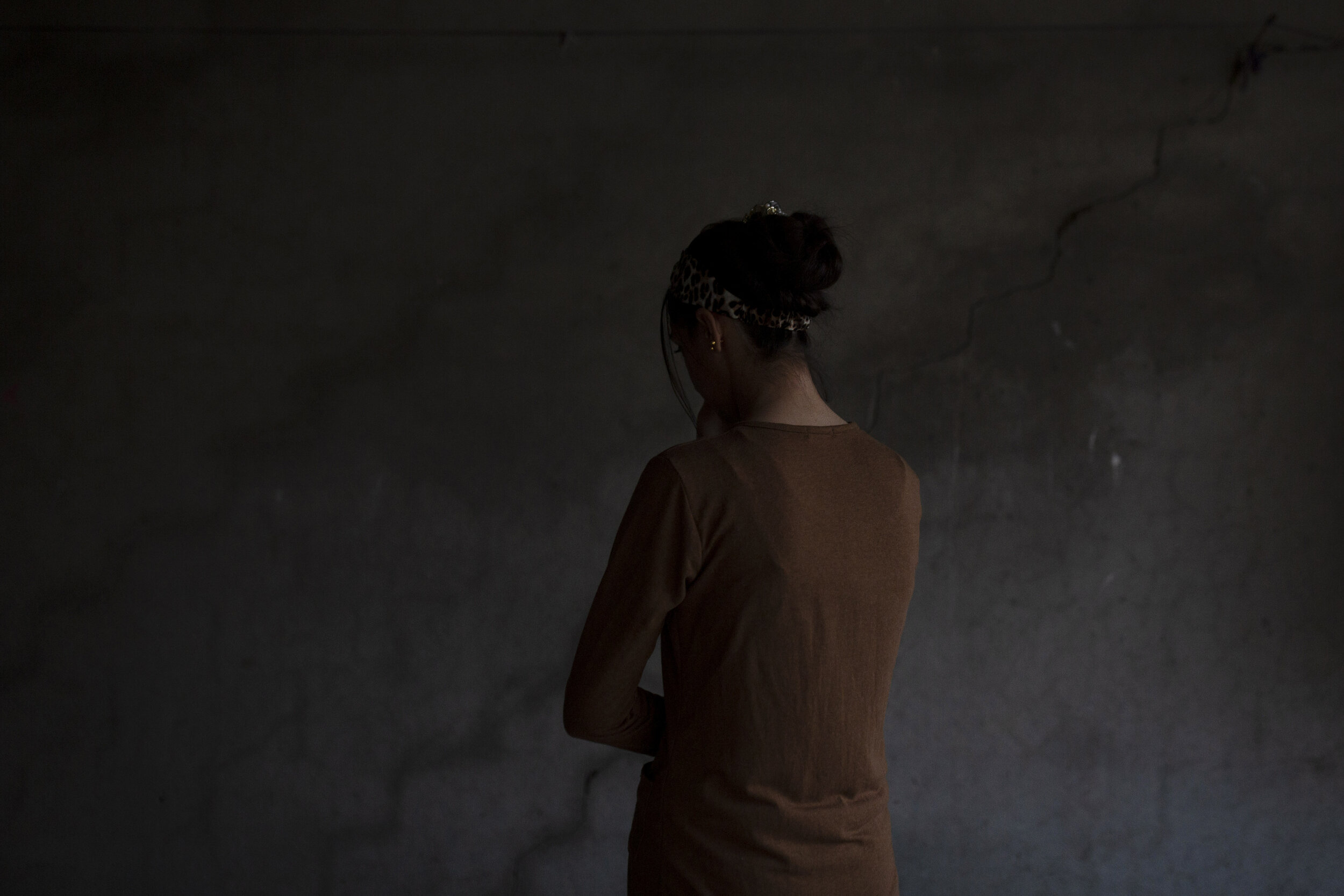 A Yazidi woman who endured five years of captivity by Islamic State militants poses for a portrait in her home in northern Iraq. “They beat me and sold me and did everything to me,” she says. Raped by nearly a dozen owners over years of captivity, s