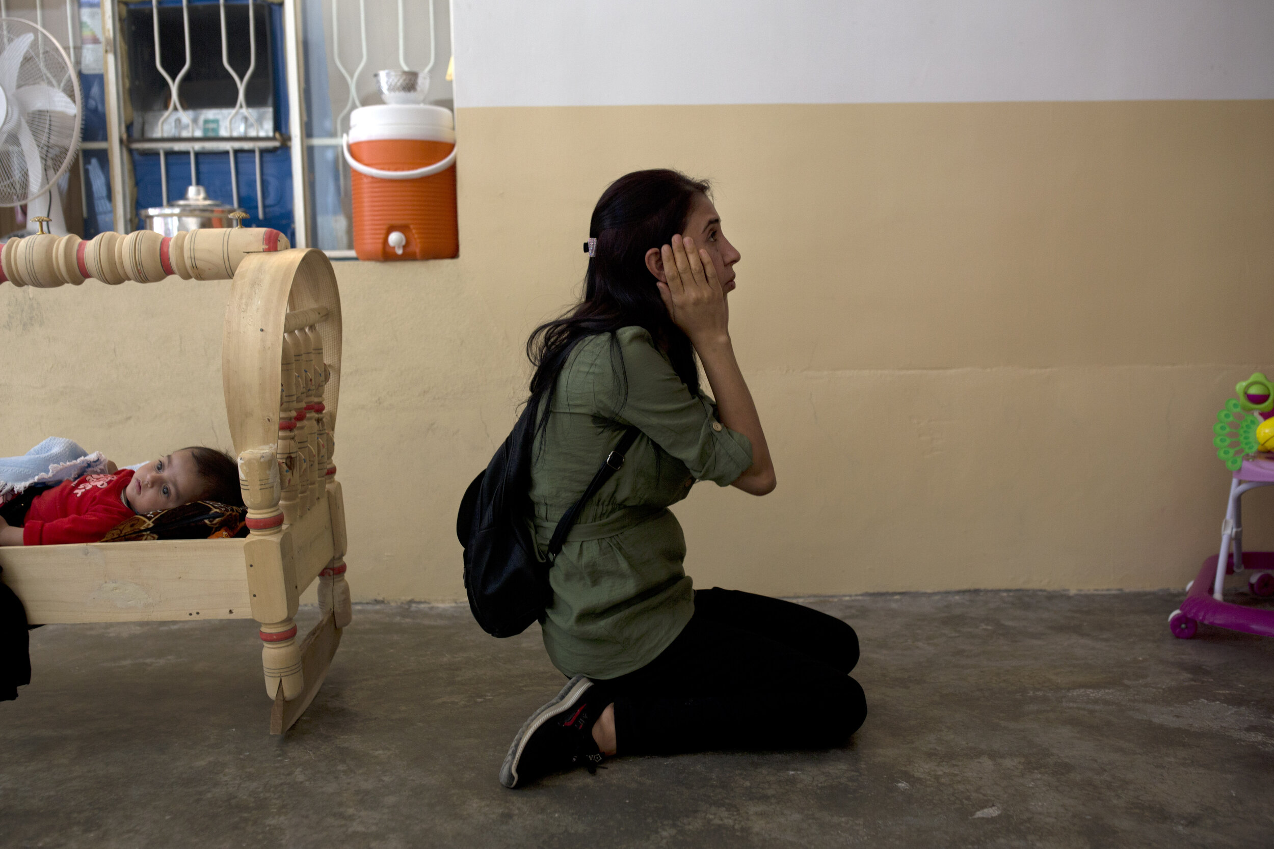 Layla Taloo visits the house where she was held along with her husband and children after Islamic State militants captured the family in Tal Afar, Iraq in 2014. It was the last place she saw her husband. (AP Photo/Maya Alleruzzo)