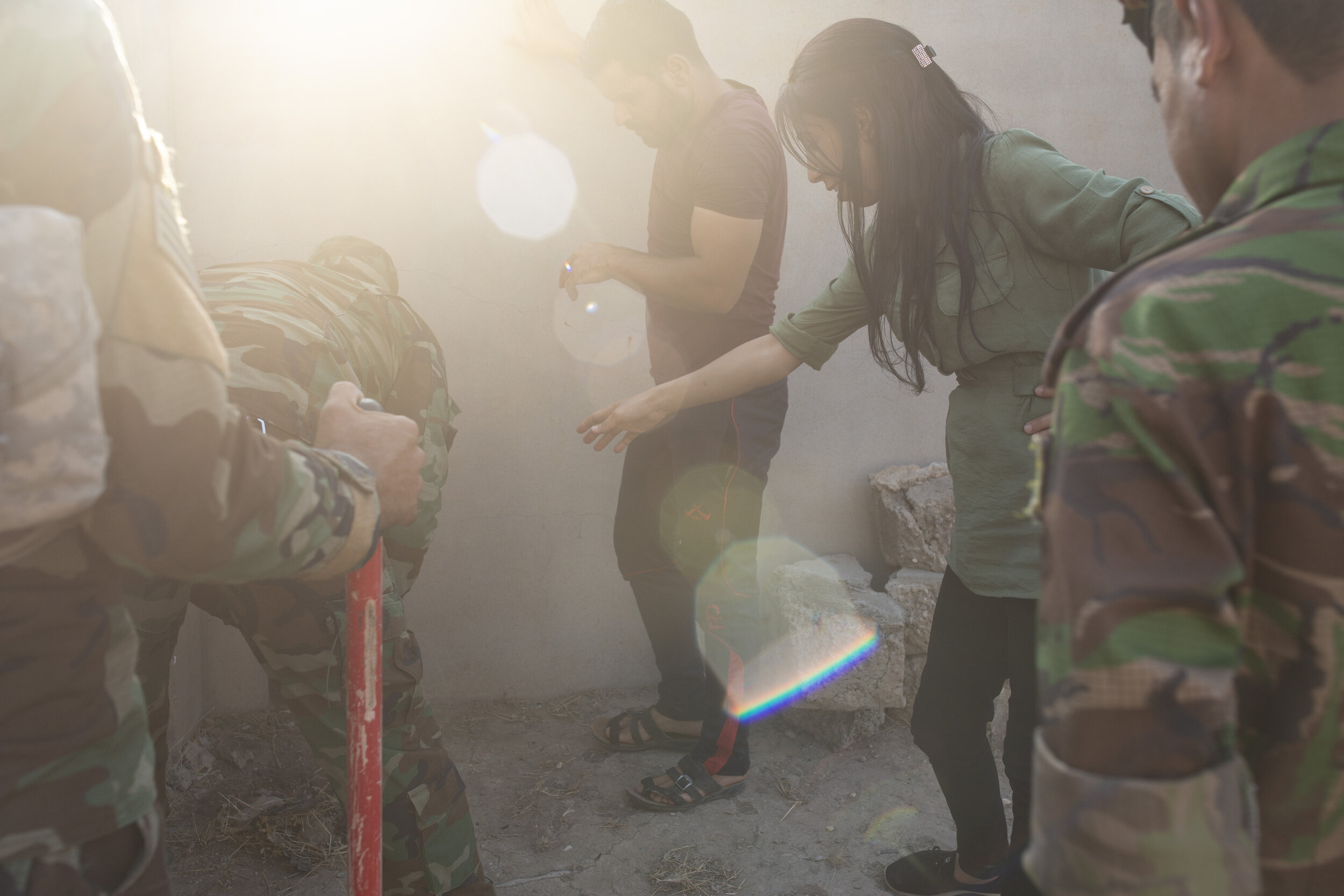 Layla Taloo directs security forces digging in the garden where she buried her mobile phone and cigarettes while being held by Islamic State militants in Tal Afar, Iraq in 2014. (AP Photo/Maya Alleruzzo)