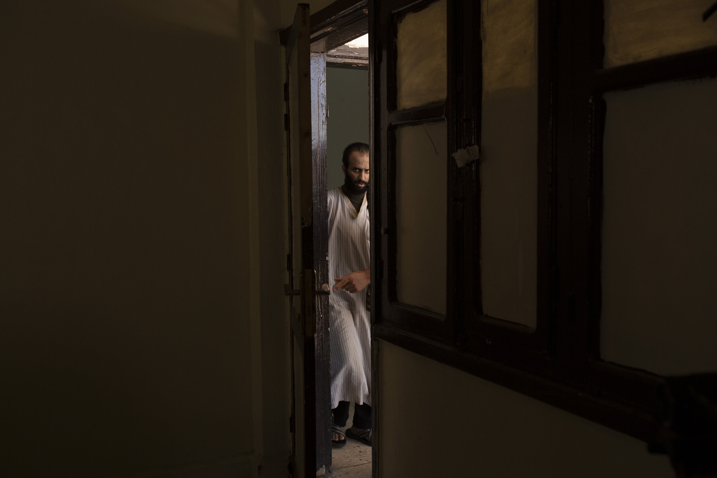 Abdul-Rahman al-Shmary, a Saudi Islamic State militant who traded in Yazidi slaves, is led byKurdish prison guards to an interview in Rmeilan, northeast Syria. He dismissed the IS rules on slavery as rooted not in Islamic law but in the leadership’s