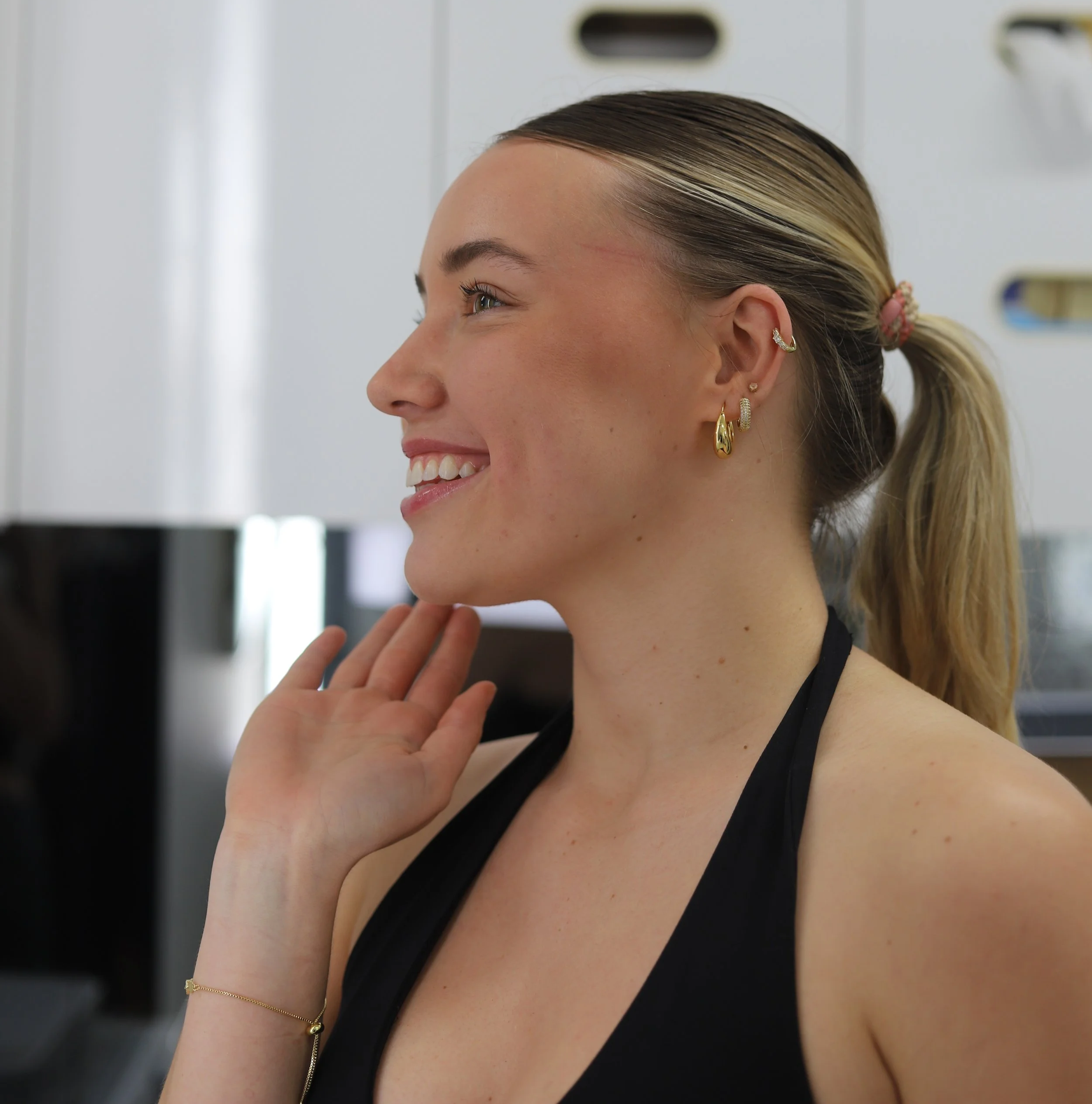 Female at the dentist smiling at Brisbane Smile Boutique after composite resin veneers with Dr Leila Haywood, one of Brisbane's most accomplished female cosmetic dentists in Spring Hill, in inner city Brisbane
