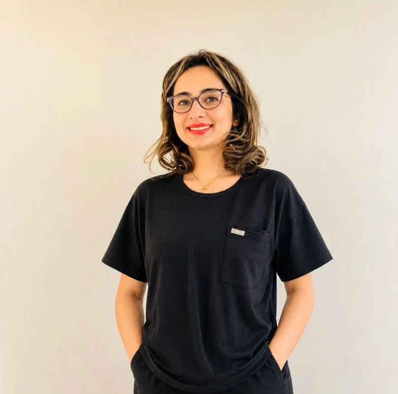 Photo of beautiful young woman posed on a chair in a photo studio, a dentist, Dr Diane Nguyen