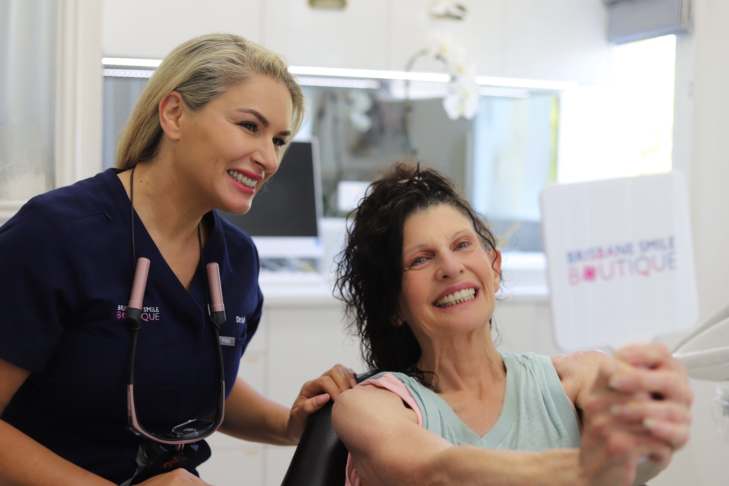 female dentist, dr Leila Haywood, at Brisbane Smile Boutique, in inner city Brisbane with an older female patient who has had cosmetic dentistry treatment