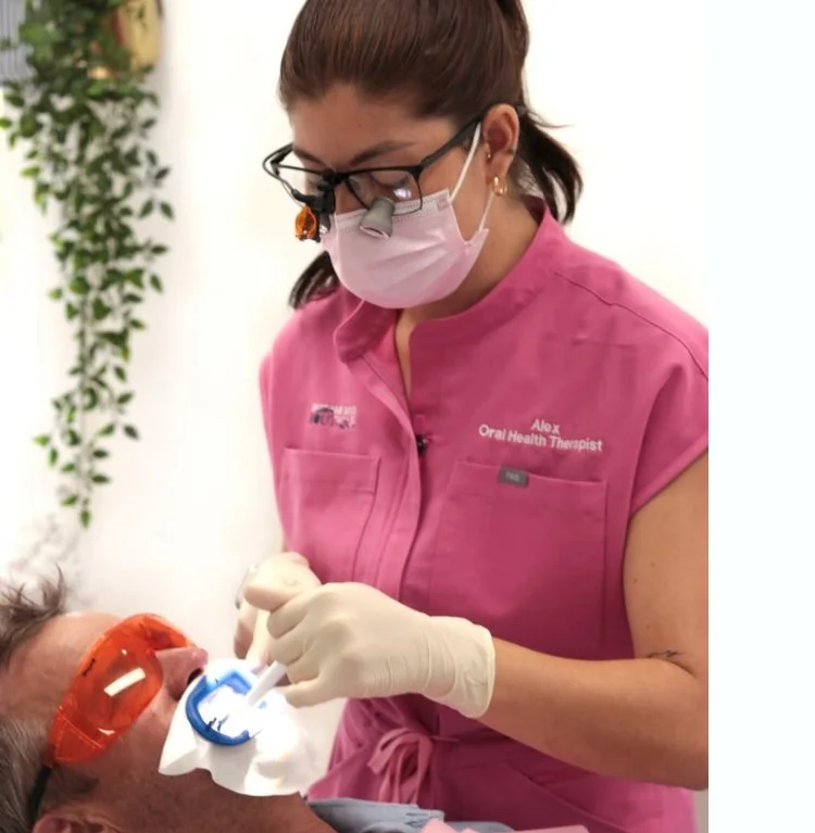 female oral health therapist at Brisbane Smile Boutique doing whitening on a patient