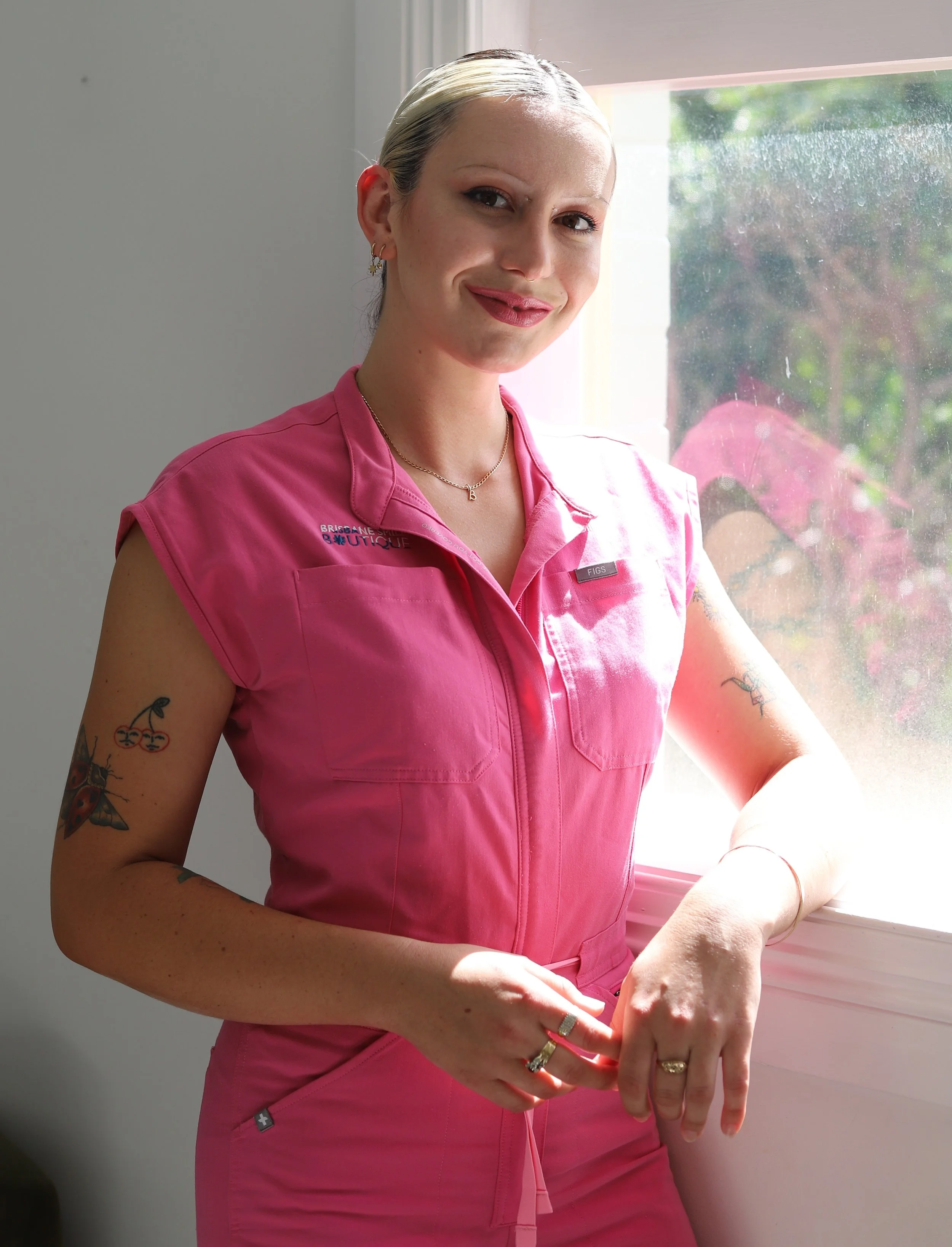 Female Dental Professional in Navy Blue scrubs in a leather chair