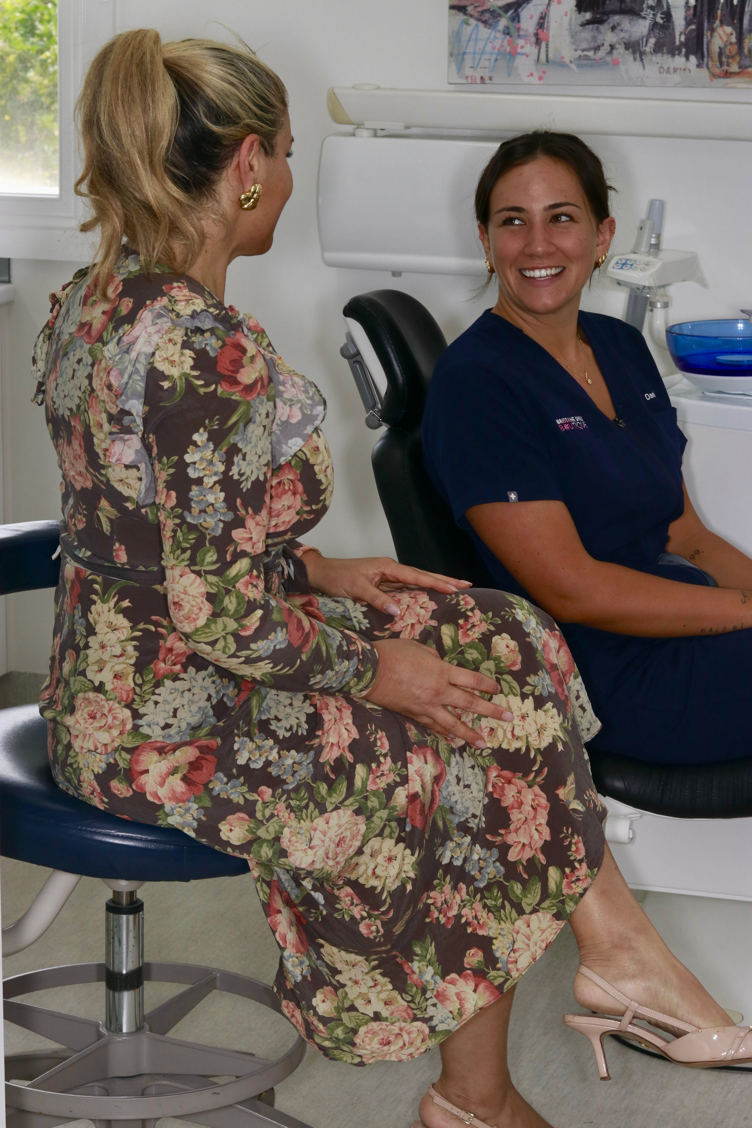 female dentist talking to a female patient in the dental chair about dental Implant Restoration – Natural Aesthetic Results