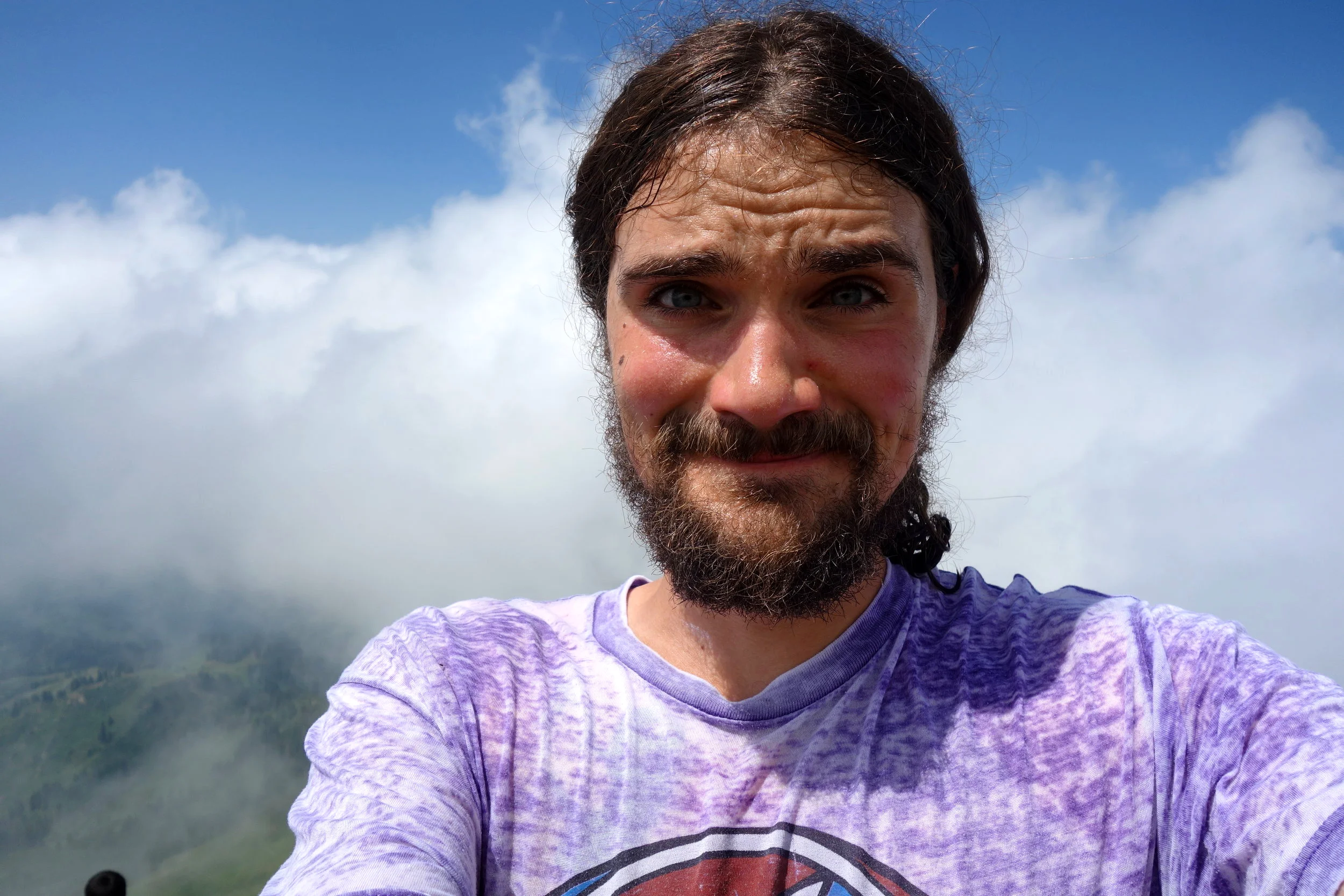 Top of a mountain, in the clouds and wearing a Grateful Dead shirt. The Life.