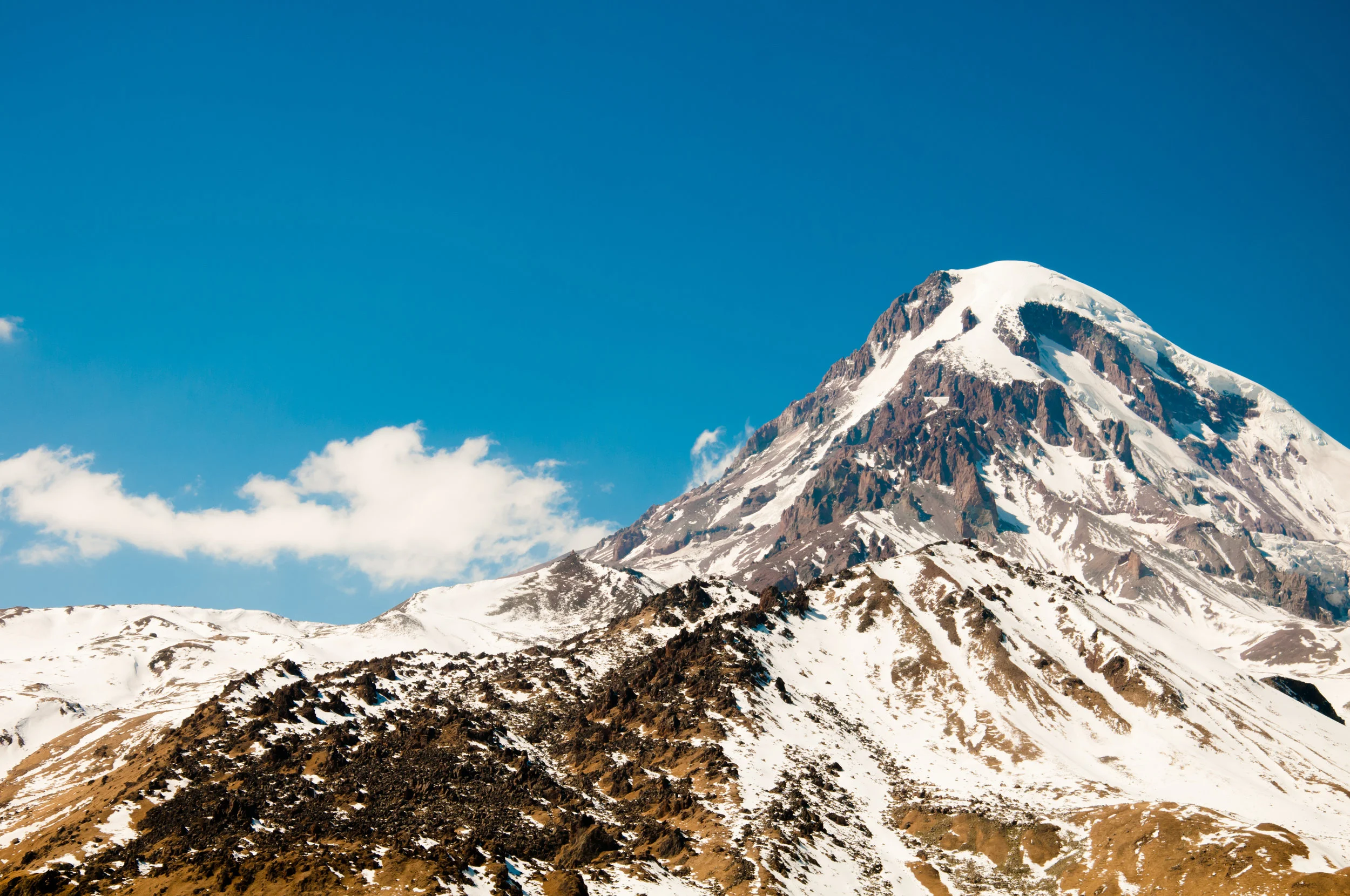 Caucasus-mountain-range-in-spring-with-snow-and-blue-sky-485675193_4288x2848.jpeg