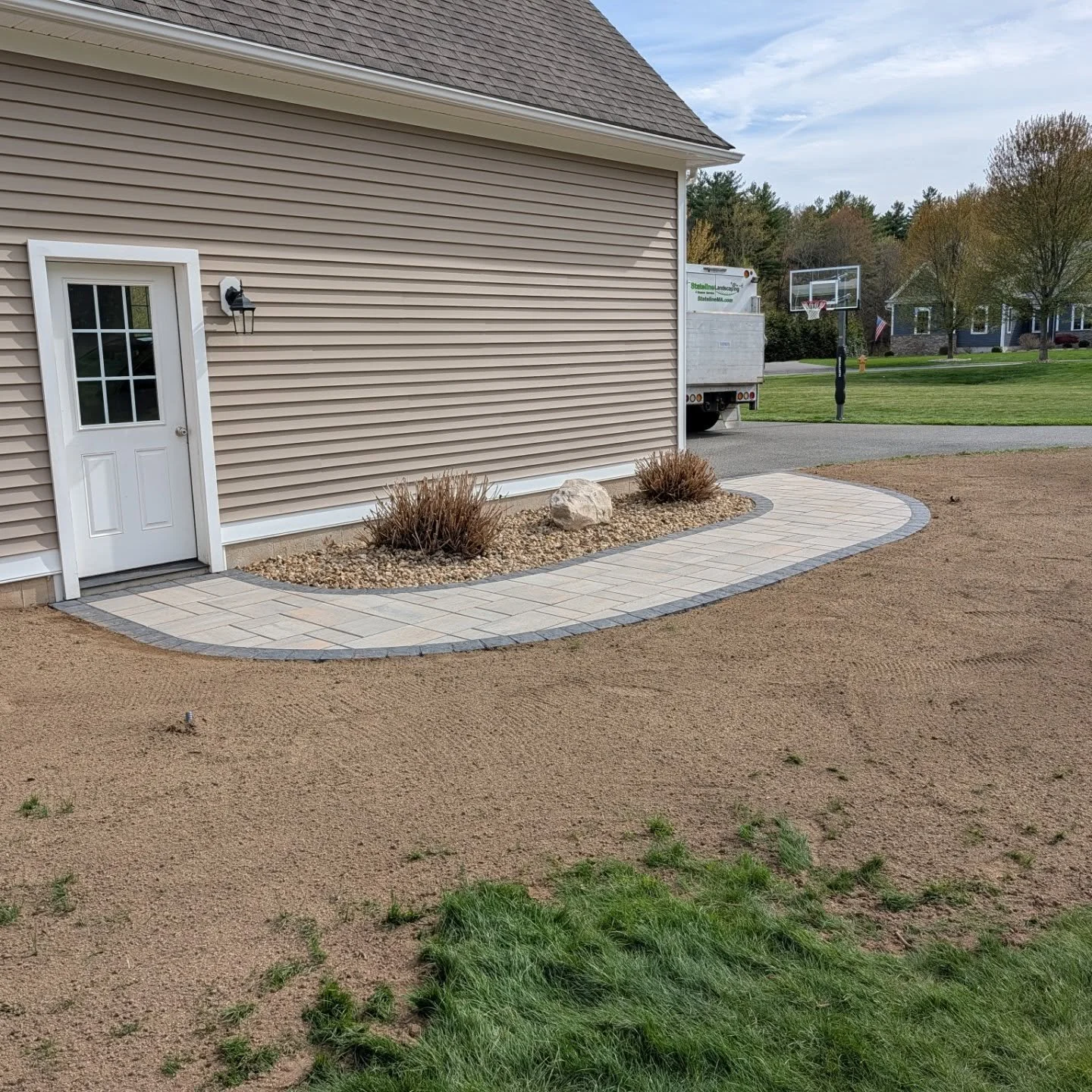 Walkway installation we just completed. Techo Bloc Blu 60 in Champlain Gray with a Valet border in Onyx black @techobloc material provided by our friends at @ondricknaturalearth! #hardscapes