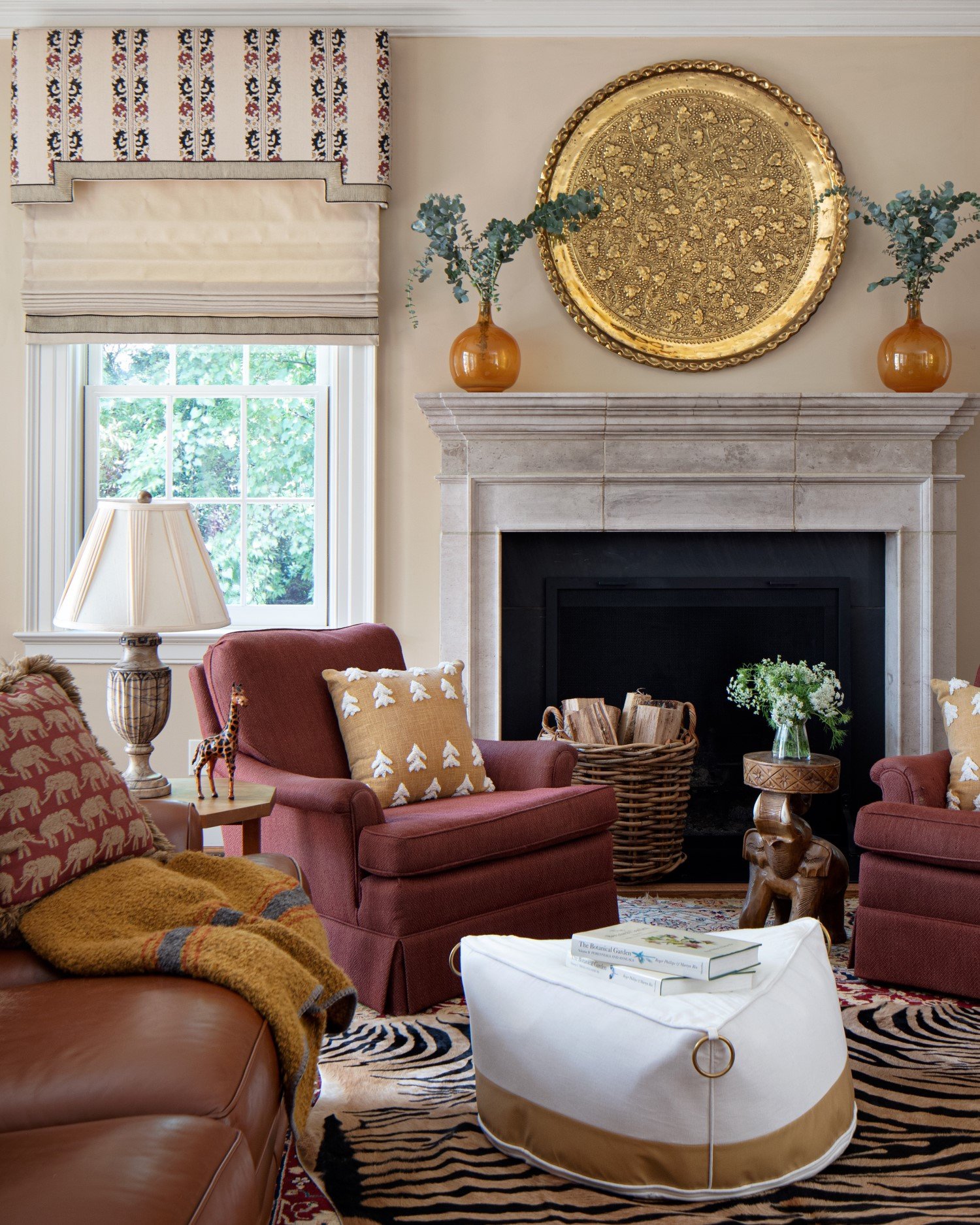  A mix of autumnal hues brought together in this living room by color expert Susan Jamieson brings warmth to the space with its stone fireplace and zebra rug 
