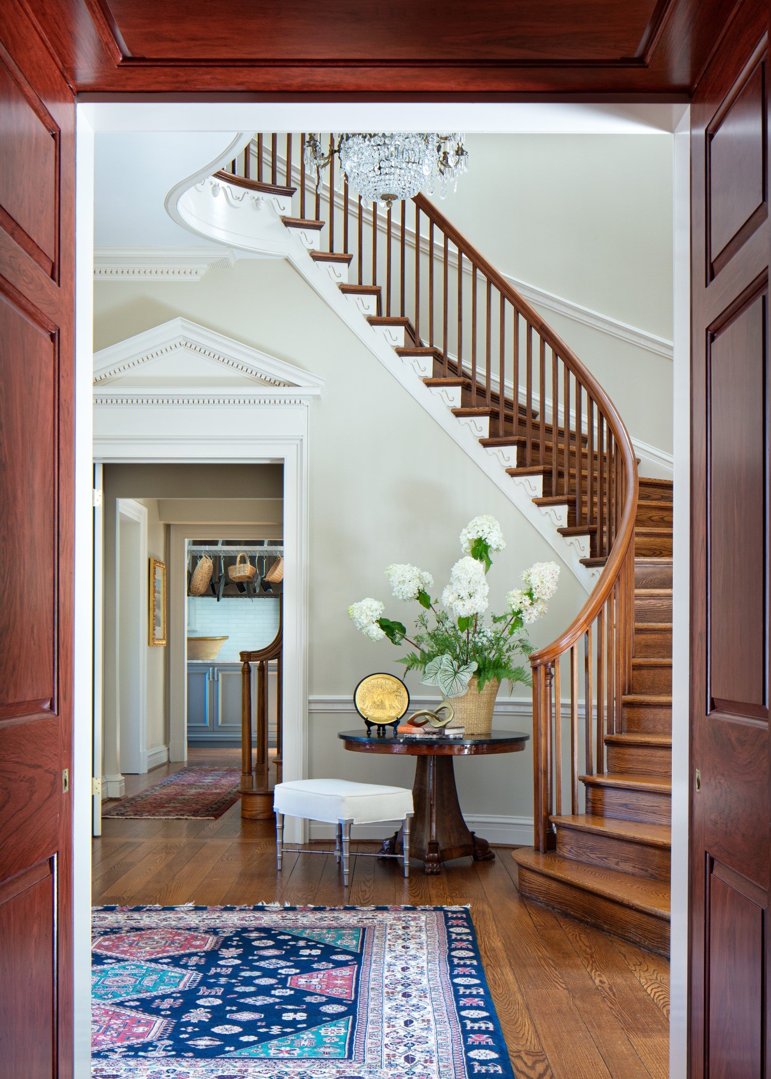  A graceful curved stairway that is a classic fixture in traditional homes from the turn of the century, the color palette and furnishings by Susan Jamieson, an historic-renovation expert 