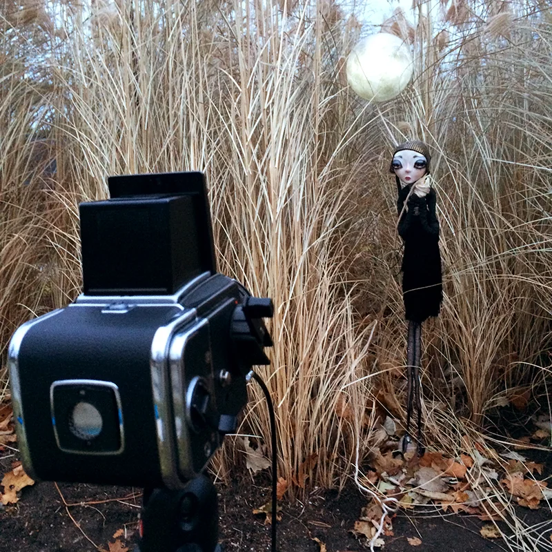 The portrayal of the doll, her props, and the environment she finds herself all seamlessly invite us to immerse ourselves in those moments, to play with them and reflect on them in the safety of a photograph