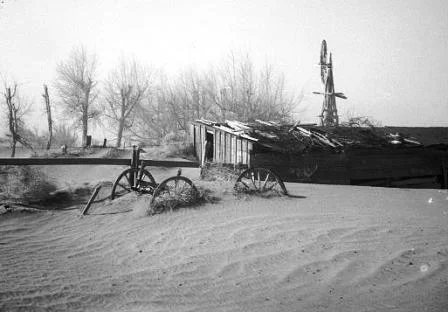 The aftermath of a dust storm, burying farm equipment and building (photo courtesy of american-historama.org )