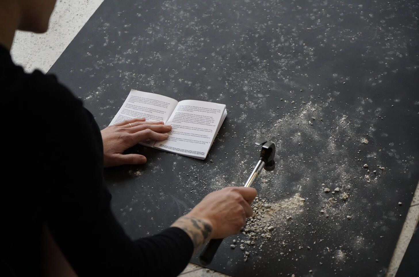  Rachel Lindsay-Snow, Constellation, Installation (Rocks, The UN Convention on the Rights of the Child booklet, hammer, matte board, pinch pots, brush, paper, human), 2019.  Notes: The following three tasks are done constantly for 8-hours:  1. Hammer