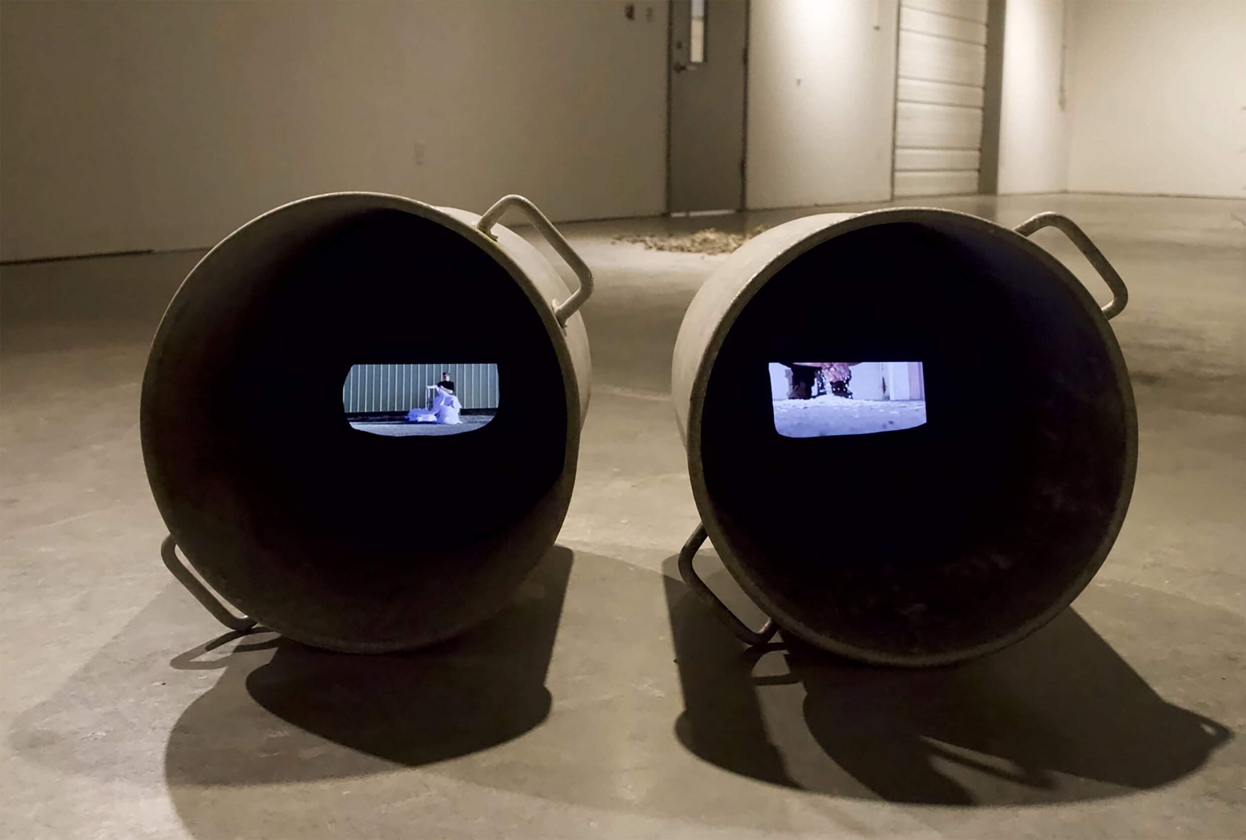  Rachel Lindsay-Snow,  When my shadow overlaps your shadow Who is the new one? , Installation (Twin pots, paper, video: performer, eggshells, fabric), 2019.  Notes: There are twin pots, each containing a video (sound on): one of a figure tearing whit