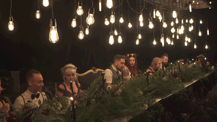cinemagraph animated gif of wedding reception head table with hanging Edison light bulbs