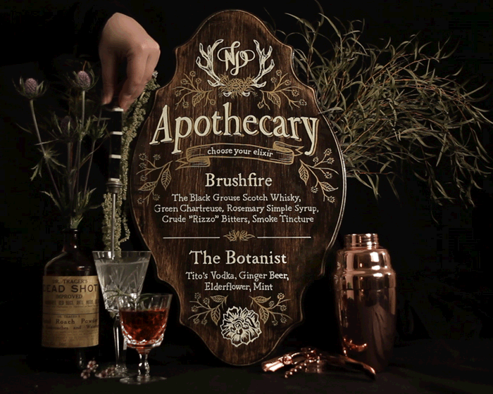 cinemagraph animated gif of custom bar sign and stirring cocktail drink