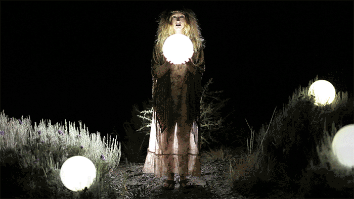 cinemagraph animated gif of gypsy with glowing orbs and moving tassels