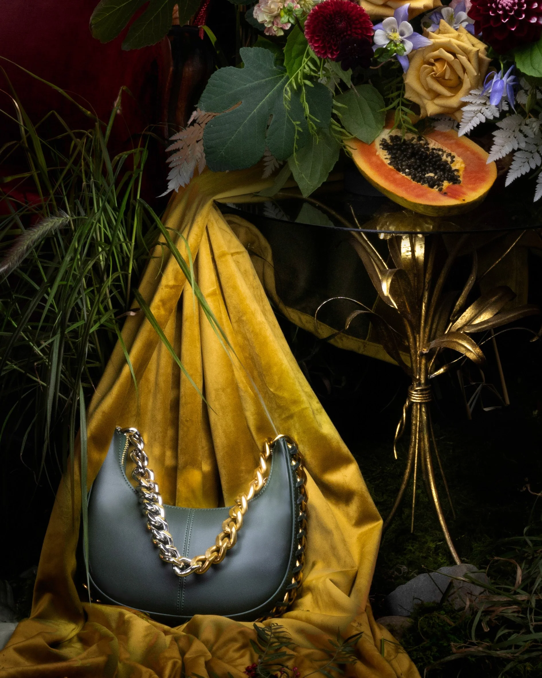  Luxury handbag with gold chain showcased in an opulent high-fashion editorial by Nightflare Creative. 