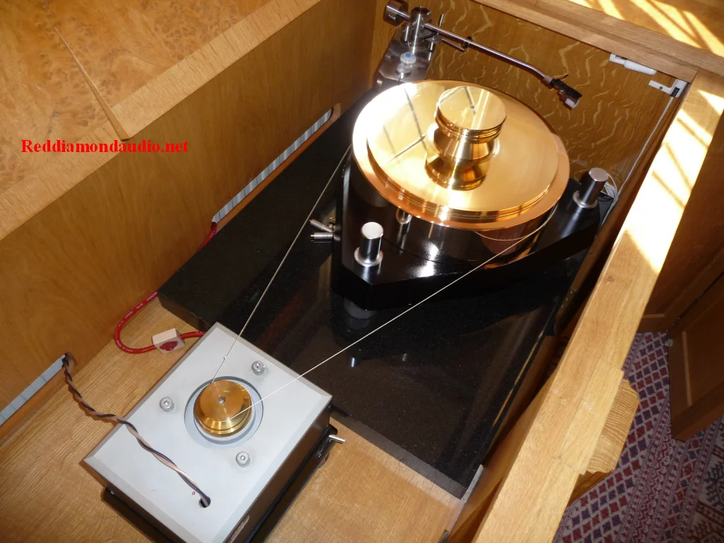 A Melco turntable system. The Melco 3560 gun metal platter, the 3256 base and 3533 motor unit. Allow 100 kg for the entire setup, excluding the extra 10 kg needed for the large record weight.