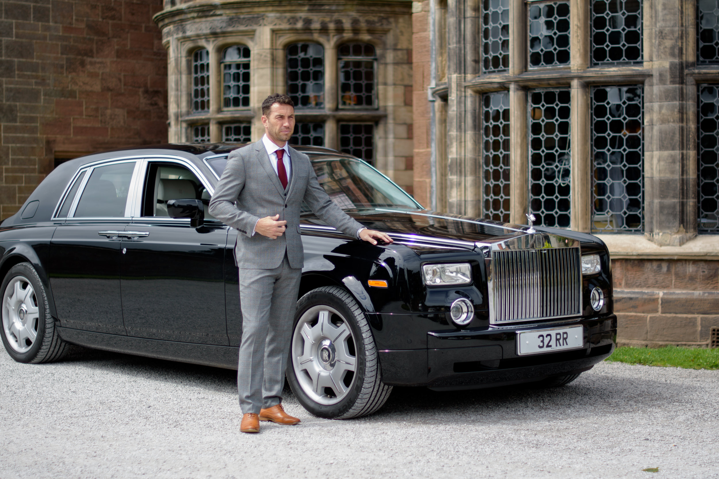 Groom standing with his Rolls Royce