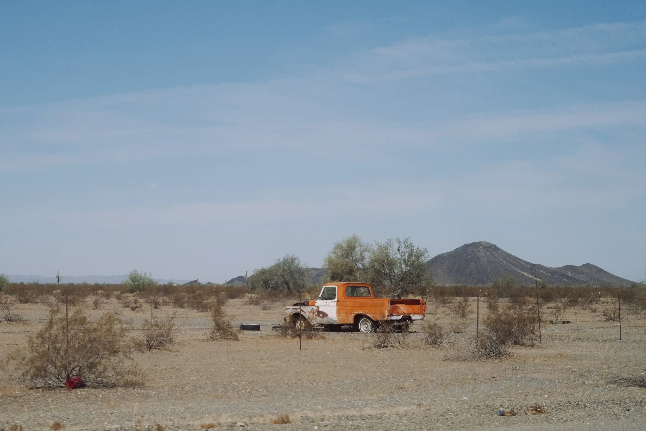  A rusting truck, baking under the desert sun. Perhaps forgotten, perhaps on life support as the rust slowly  disintegrates its body.  