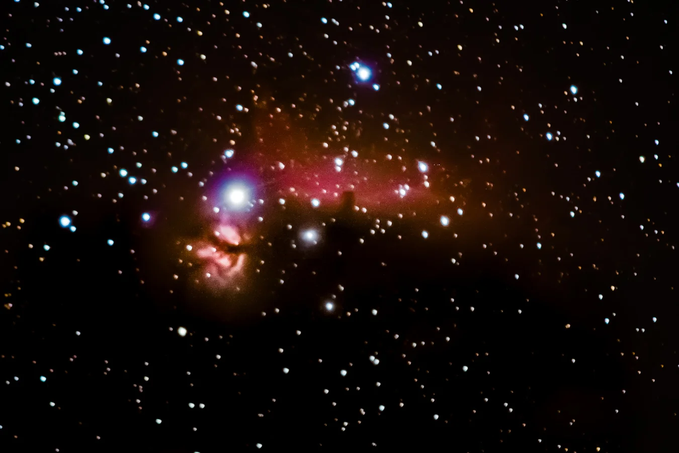 This is my favorite nebula, the Horsehead Nebula, imaged from the Nevada desert. I stacked images taken using the DSLR piggybacking atop my editorially mounted telescope using the telephoto lens (i.e., the picture was not taken through the telescope, just used its mount to track the sky). You can also see the Flame Nebula in the bottom left corner next to the bright star Alnitak in Orion's belt. I love the Horsehead Nebula so much that when she was six years old, my mom cooked me a Horsehead Nebula birthday cake.