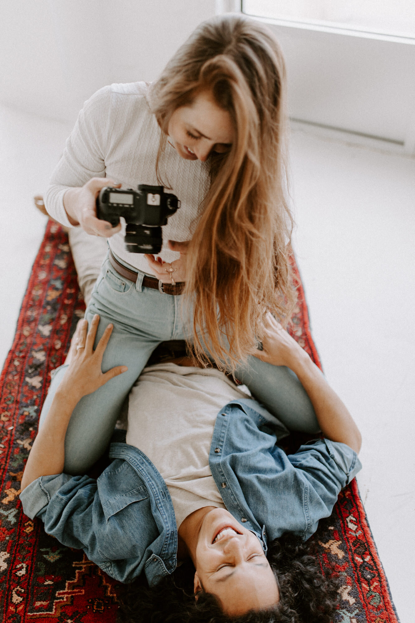 During an in home photography session with wedding photographer Diana Coulter, a Denver, Colorado couple takes photos of each other before social distancing and quarantine