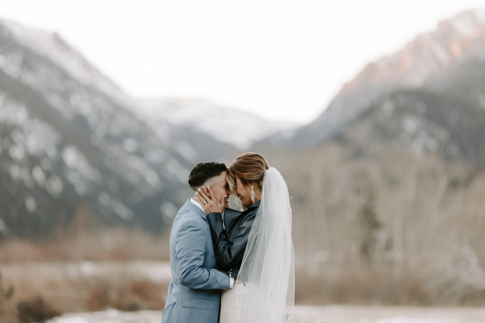 LQBTQ couple kissing in Rocky Mountain National Park after their Colorado elopement at sunset with wedding photographer Diana Coulter