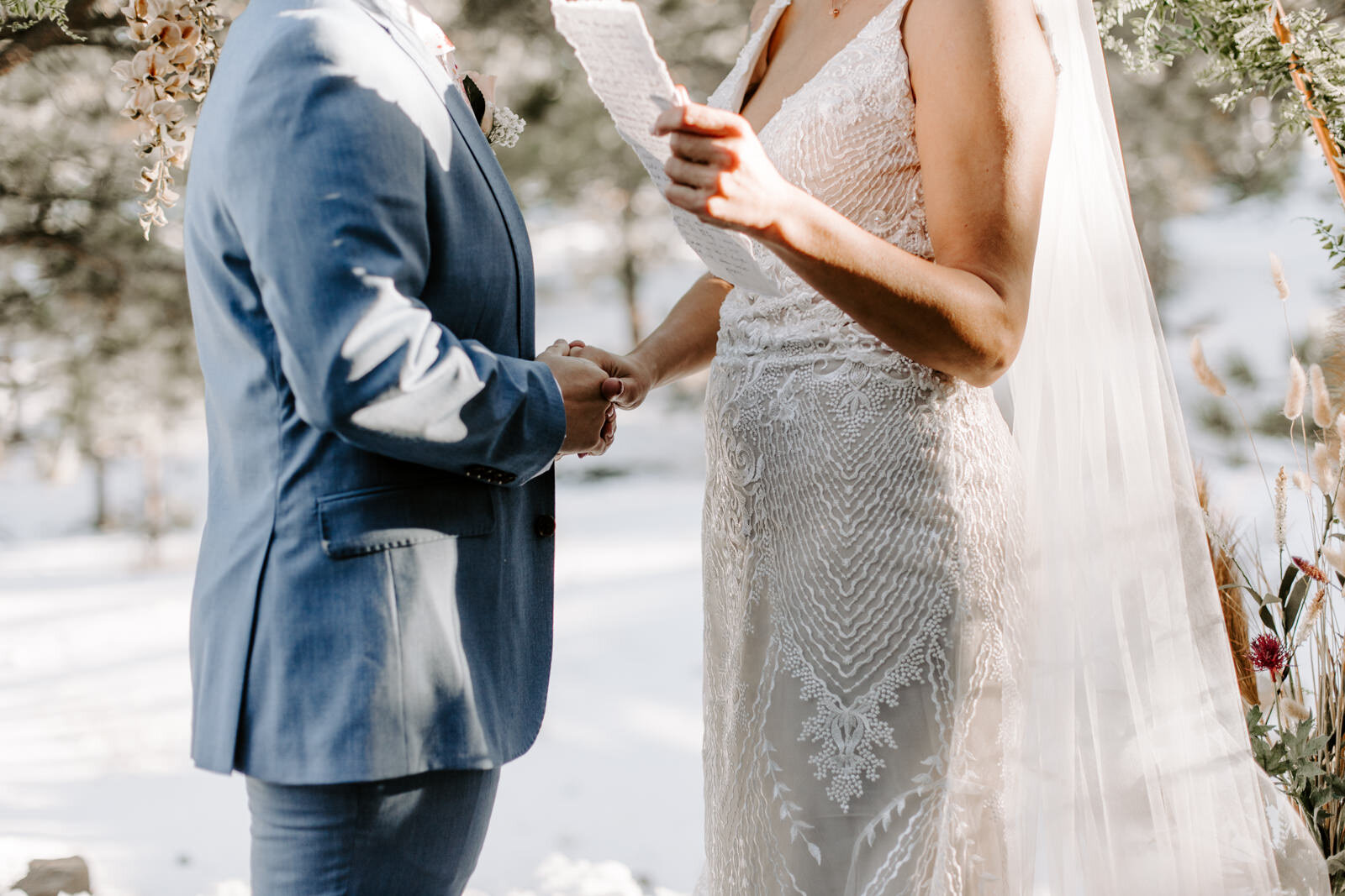 LGBTQ couple exchange written vows while holding hands at Estes Park AirBnB Elopement for an LGBTQ couple with Colorado elopement photographer Diana Coulter