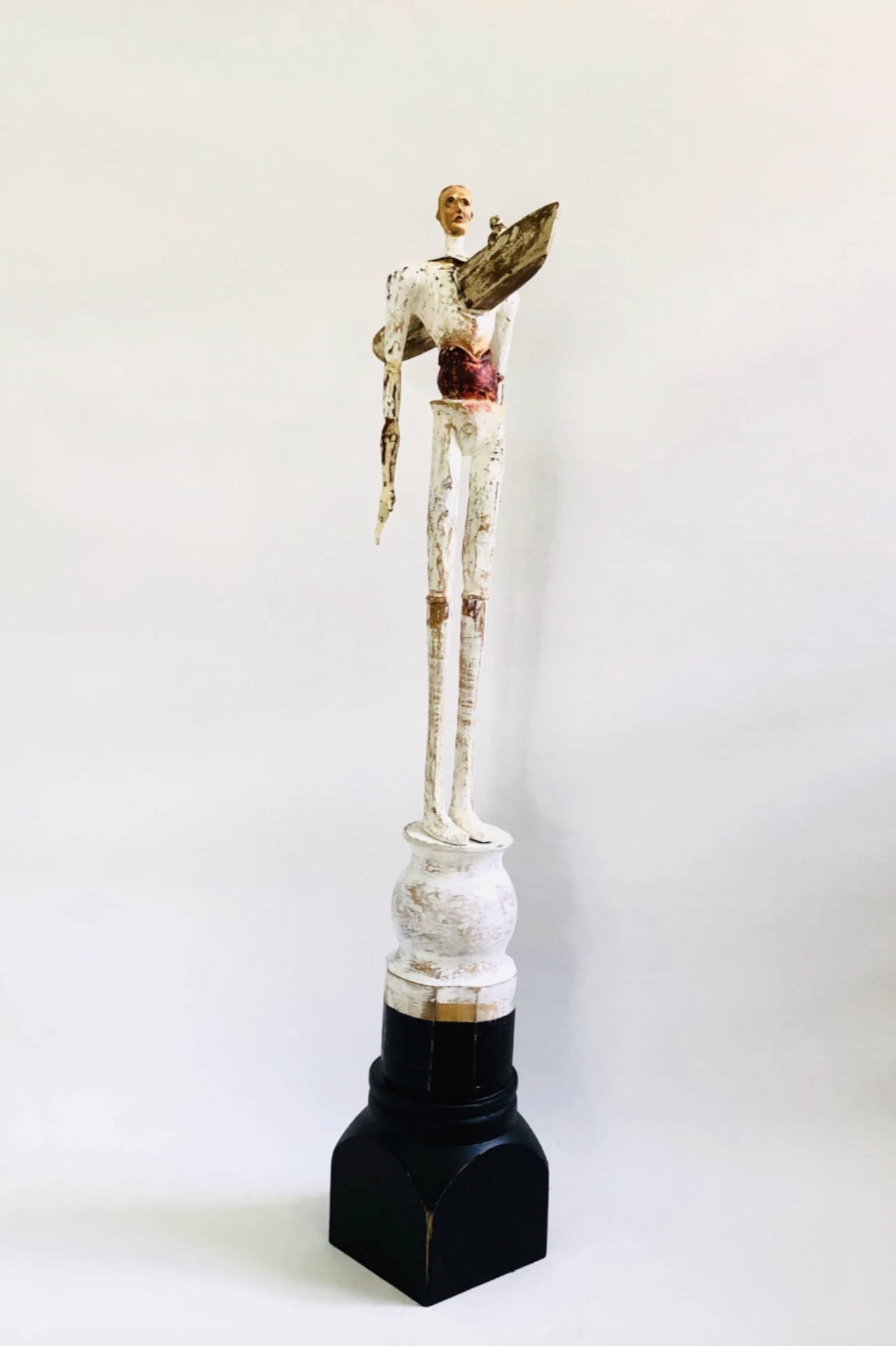 A sculpture titled Feeling Without Belonging by contemporary Cuban artist Ernesto Capdevila depicting a man with a bewildered expression with a canoe coming through his heart, at Conde Contemporary.