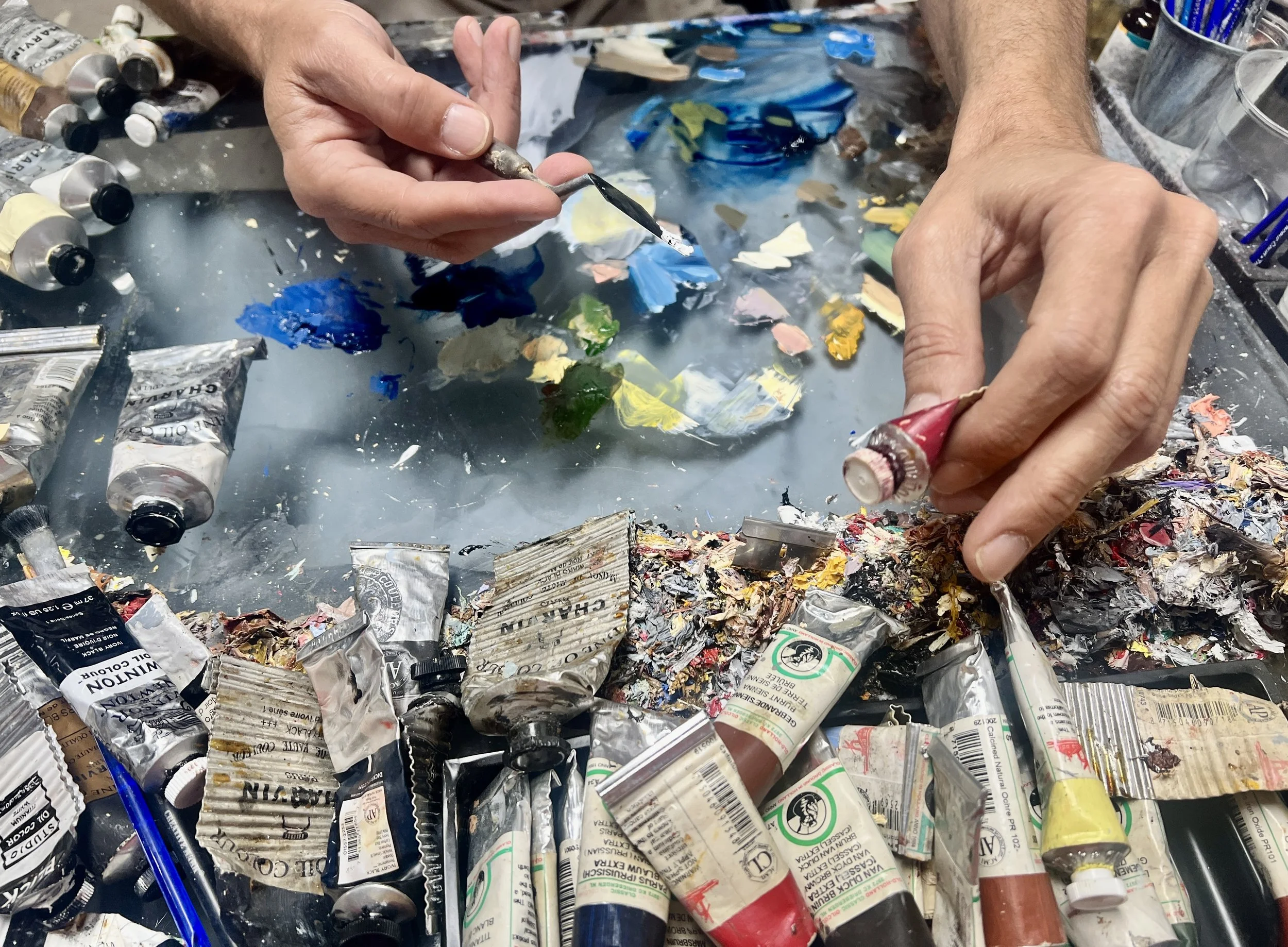 An image of Cuban artist Andrés Conde's hands working in his art studio at Conde Contemporary.