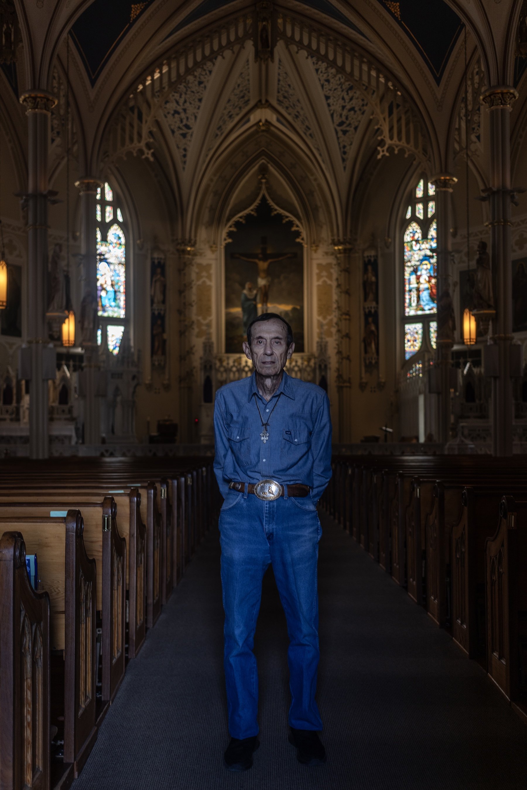 A color photo of a man in jeans inside St. Mary's Basilica in Natchez, Mississippi, photographed by contemporary photographer Alon Skuy for Conde Contemporary.