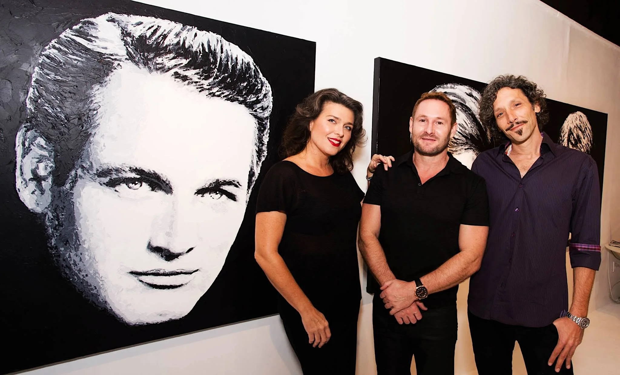 A photo from the solo exhibition Divos featuring the work of Havi Schanz, pictured here with art dealer and curator Stacy Conde and husband, Cuban pop realist artist Andrés Conde.