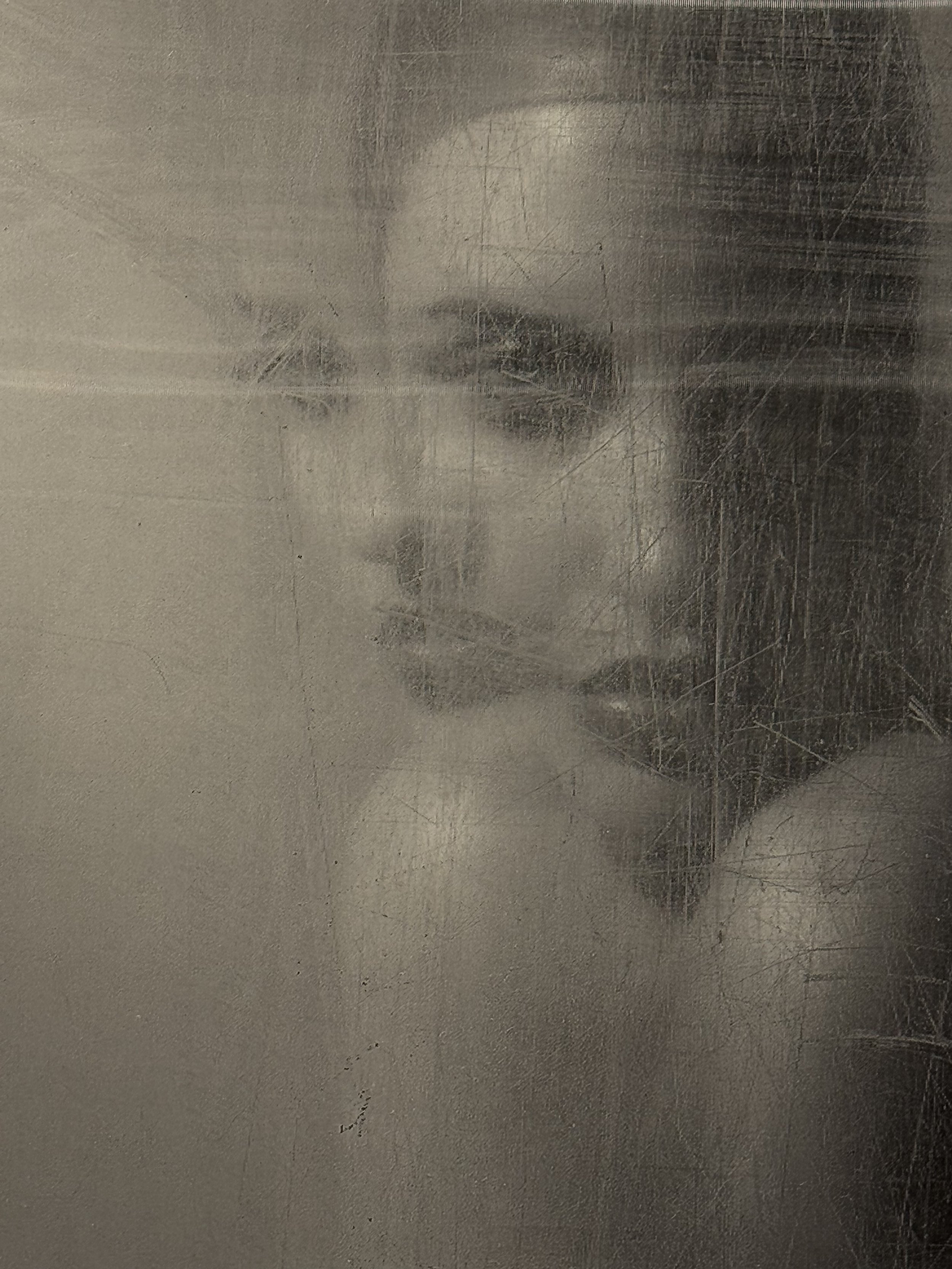 A lenticular photograph, or photograph where the image moves as you walk past it, by Russian photographer Natasha Kertes, the image is of a beautiful woman in black and white take from behind a scratched glass, available at Conde Contemporary.