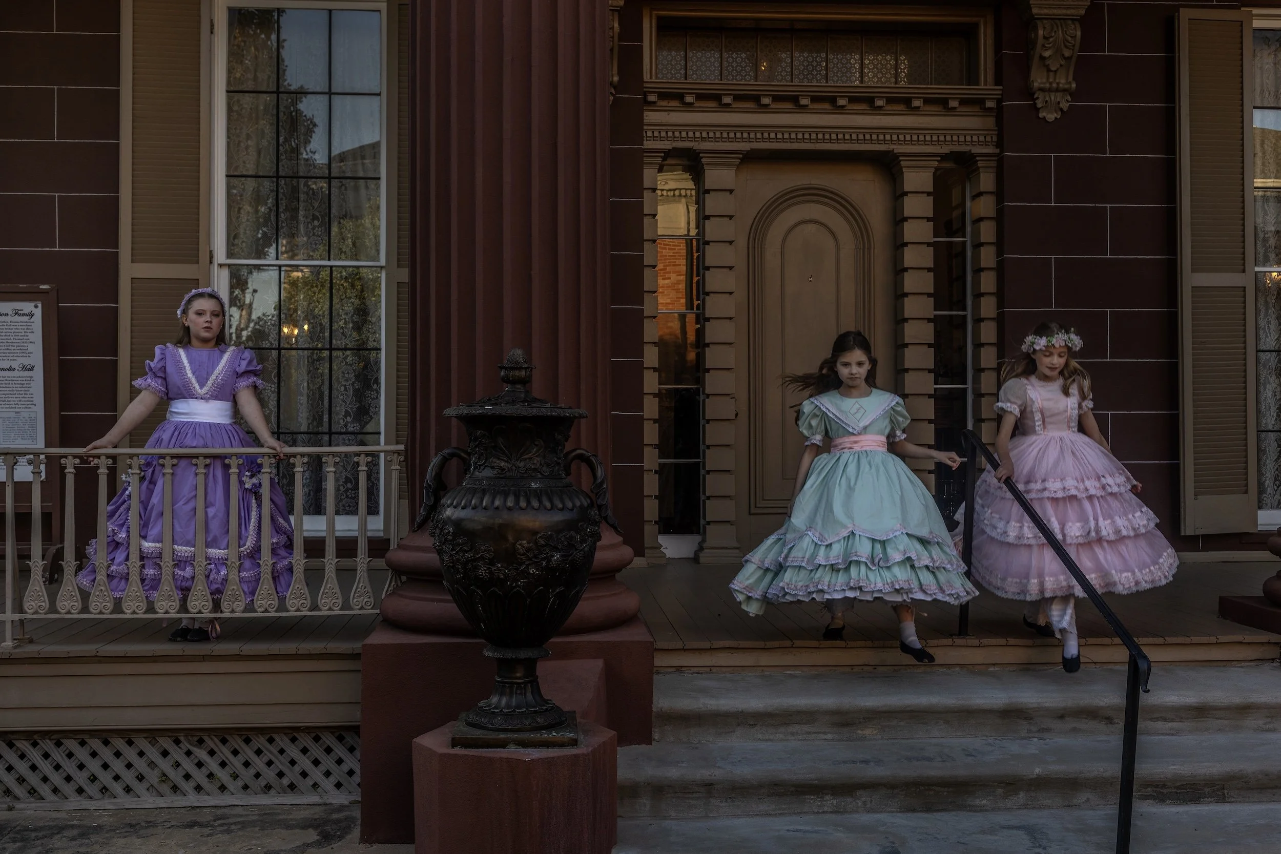 A color photo of three young girls dressed for Pilgrimage in Natchez, Mississippi, photographed by contemporary fine art photographer Alon Skuy, for Conde Contemporary.