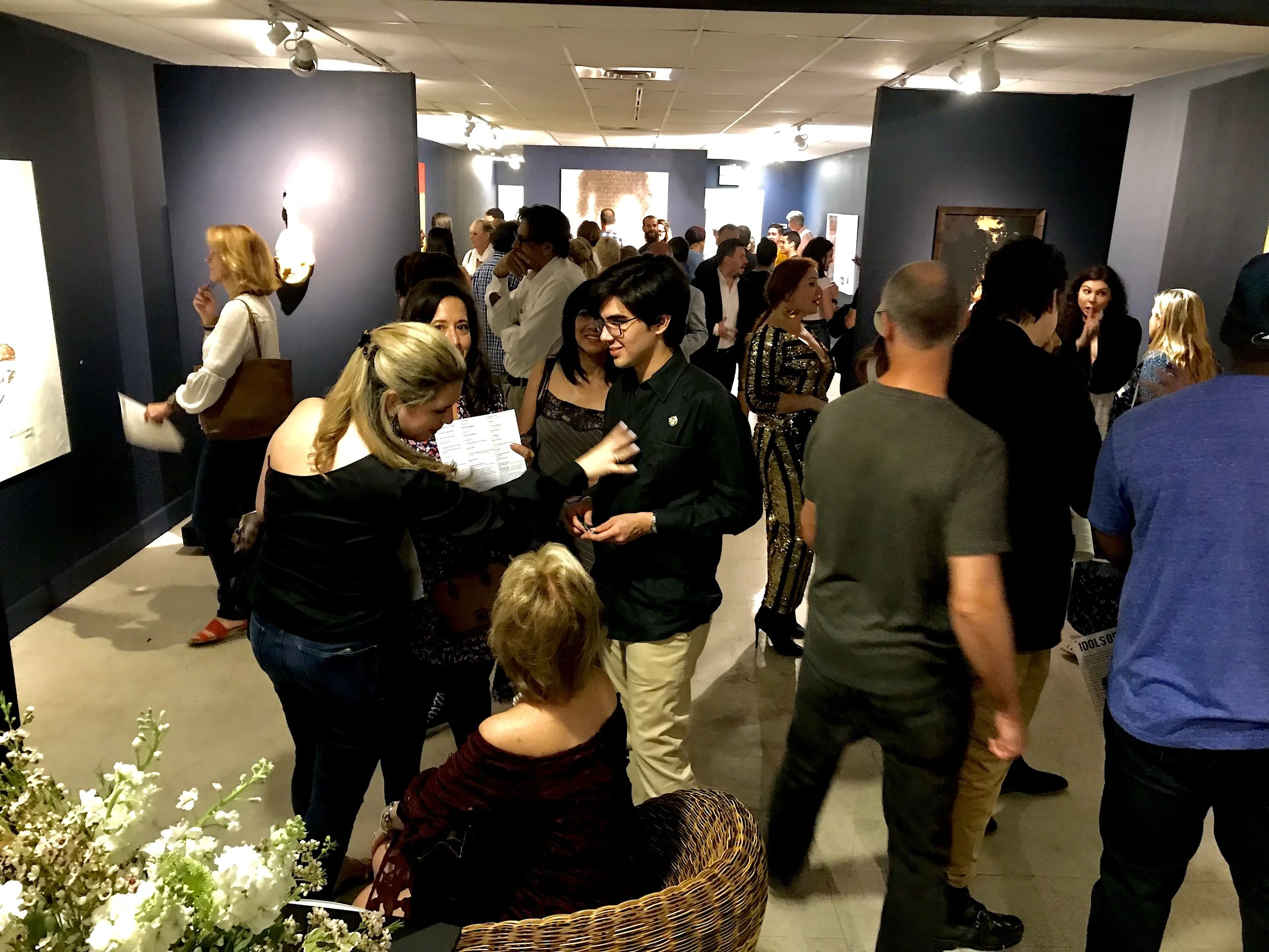 A photo of a group gathered for the opening of the group exhibition, Idols of The Tribe, curated by Stacy Conde, at Conde Contemporary's former location in Coral Gables.