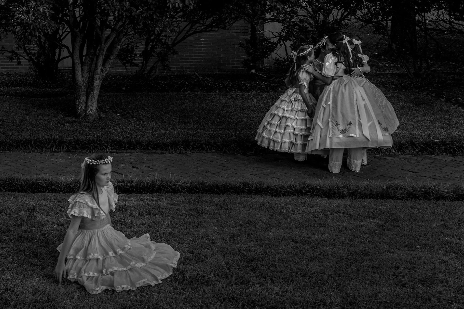 A black and white photo of four girls dressed for Pilgrimage in Natchez, Mississippi, photographed by South African photographer Alon Skuy, for Conde Contemporary.