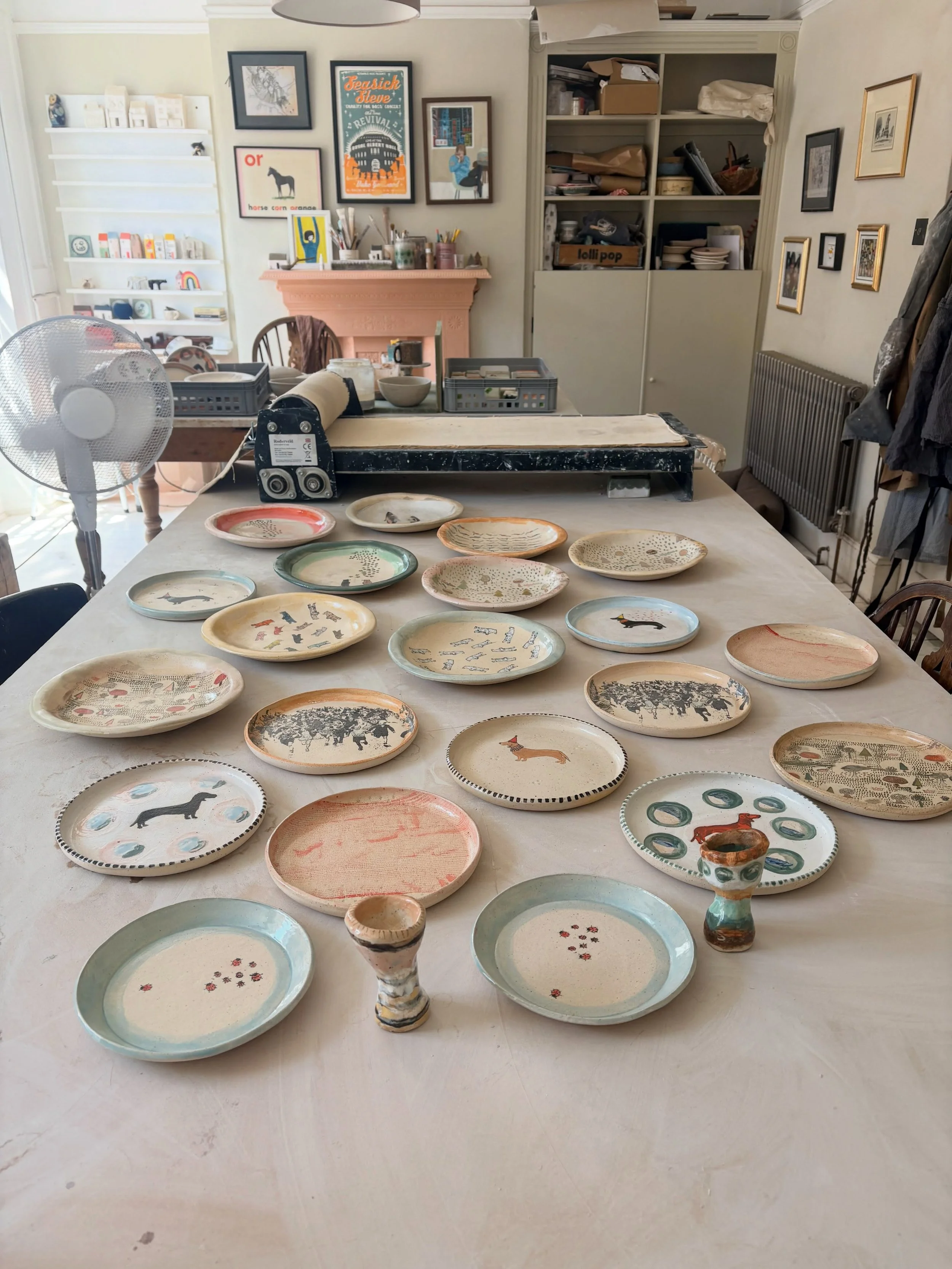 May studio right now looking very pretty in the sunshine with the plates I have just photographed for the sale all laid out like they are expecting a massive feast. 

Everything that will be for sale is now listed in my online shop  which is in previ