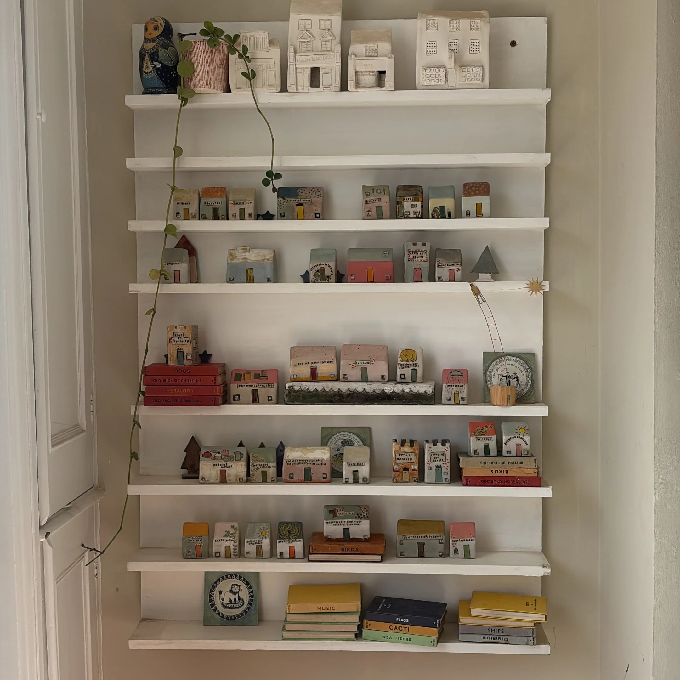 Many of the houses on these shelves are part of my next collection of work which will be available for sale on Saturday August 8th. 

I have had a lot of fun with the new collection. There will be lots of egg cups from the previous reel as well as lo