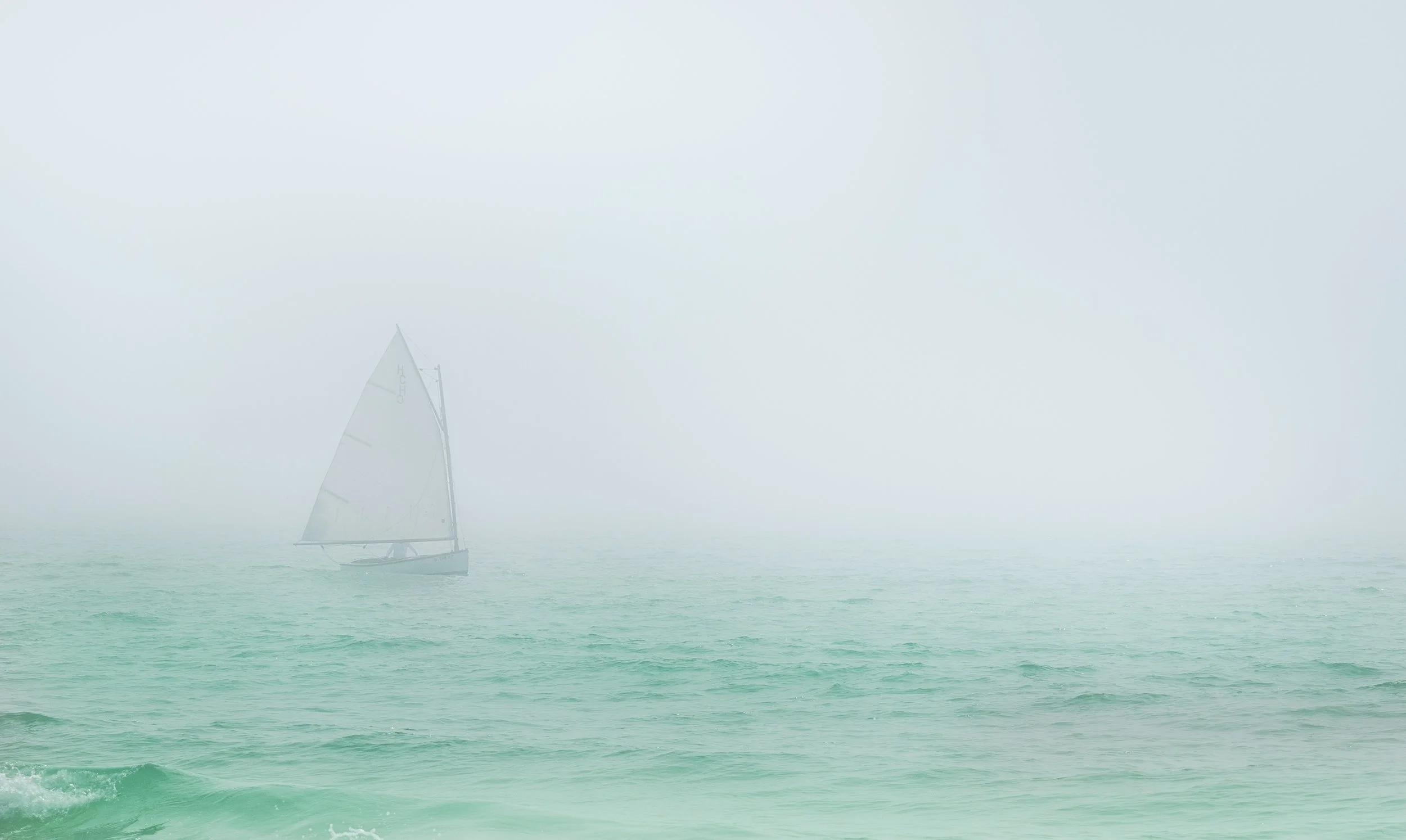 Sailboat in fog on the ocean
