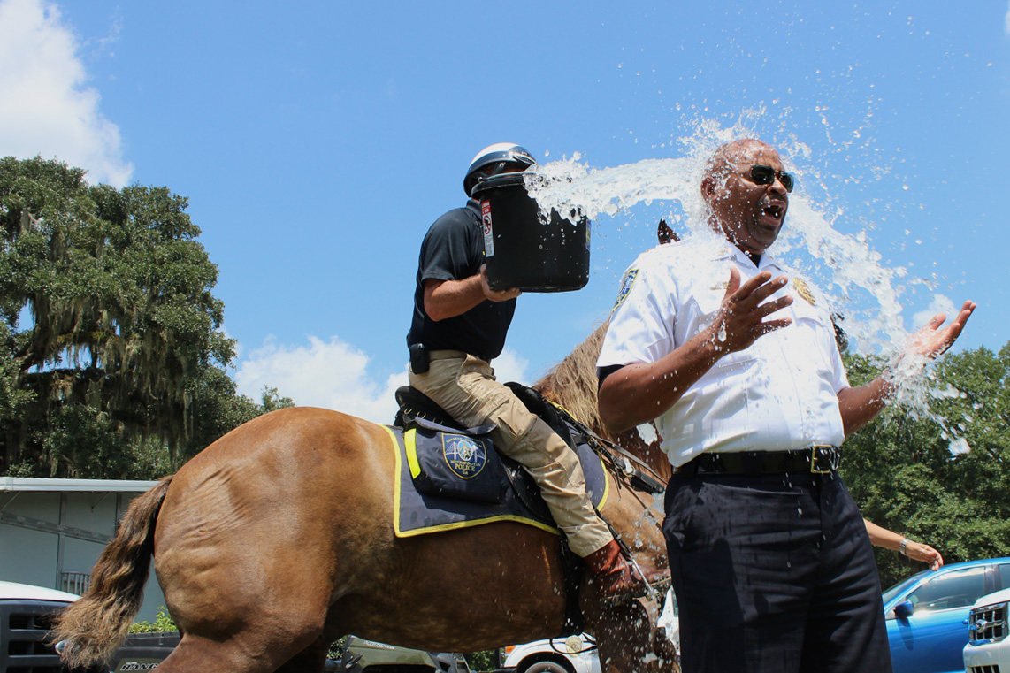  A mounted patrol officer dumps cold water on Assistant Savannah-Chatham Police Chief Terry Enoch during the height of the ALS Association's "ice bucket challenge" in August 2014. &nbsp;(Dash Coleman/Savannah Morning News) 