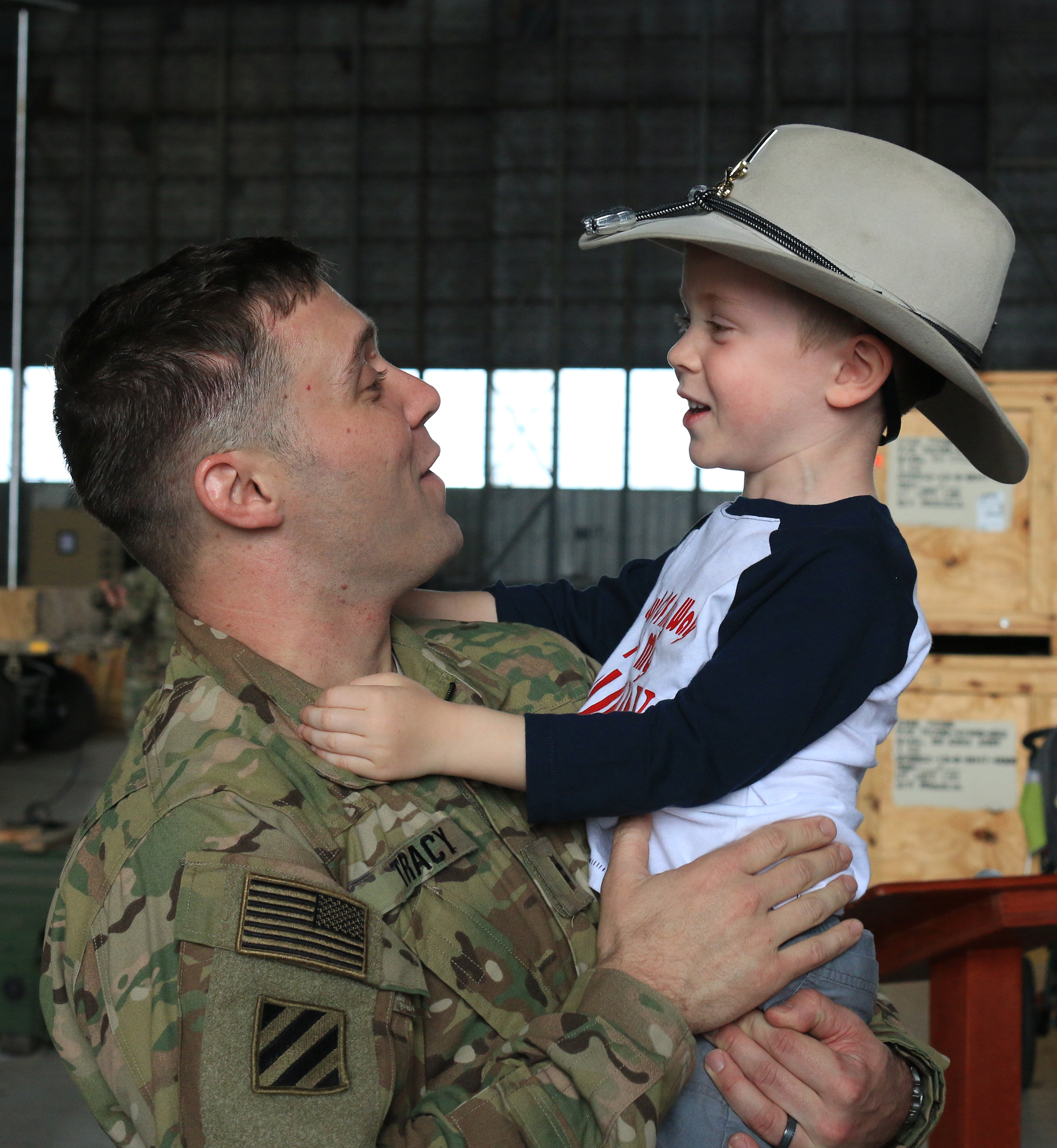  Chief Warrant Officer 2 Jon Tracy, hugs his 4-year-old son, Everett on Feb. 8, 2017, at Hunter Army Airfield after a 9-month deployment in Afghanistan. Tracy, a soldier in the 3rd Squadron, 17th Cavalry Regiment of the 3rd Infantry Division's 3rd Co