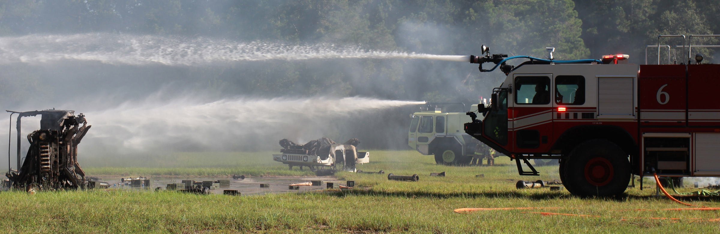  Army firefighters spray water at a smoldering Humvee one August morning at Hunter Army Airfield during Stewart Guardian 16. The training operation simulated how the Army would respond to a transport plane loaded with ammunition crashing on the insta