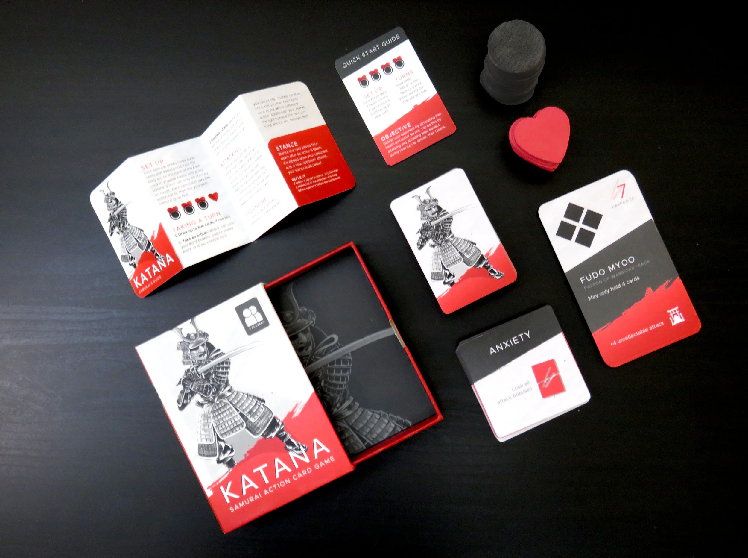Katana—Daimyō Edition includes: an Action deck (50 cards), Kami deck (12 cards), Shrine deck (24 cards), 10 Health tokens, 12 Armor tokens, Samurai's Guide, Quick Start Guide, Drawer box
