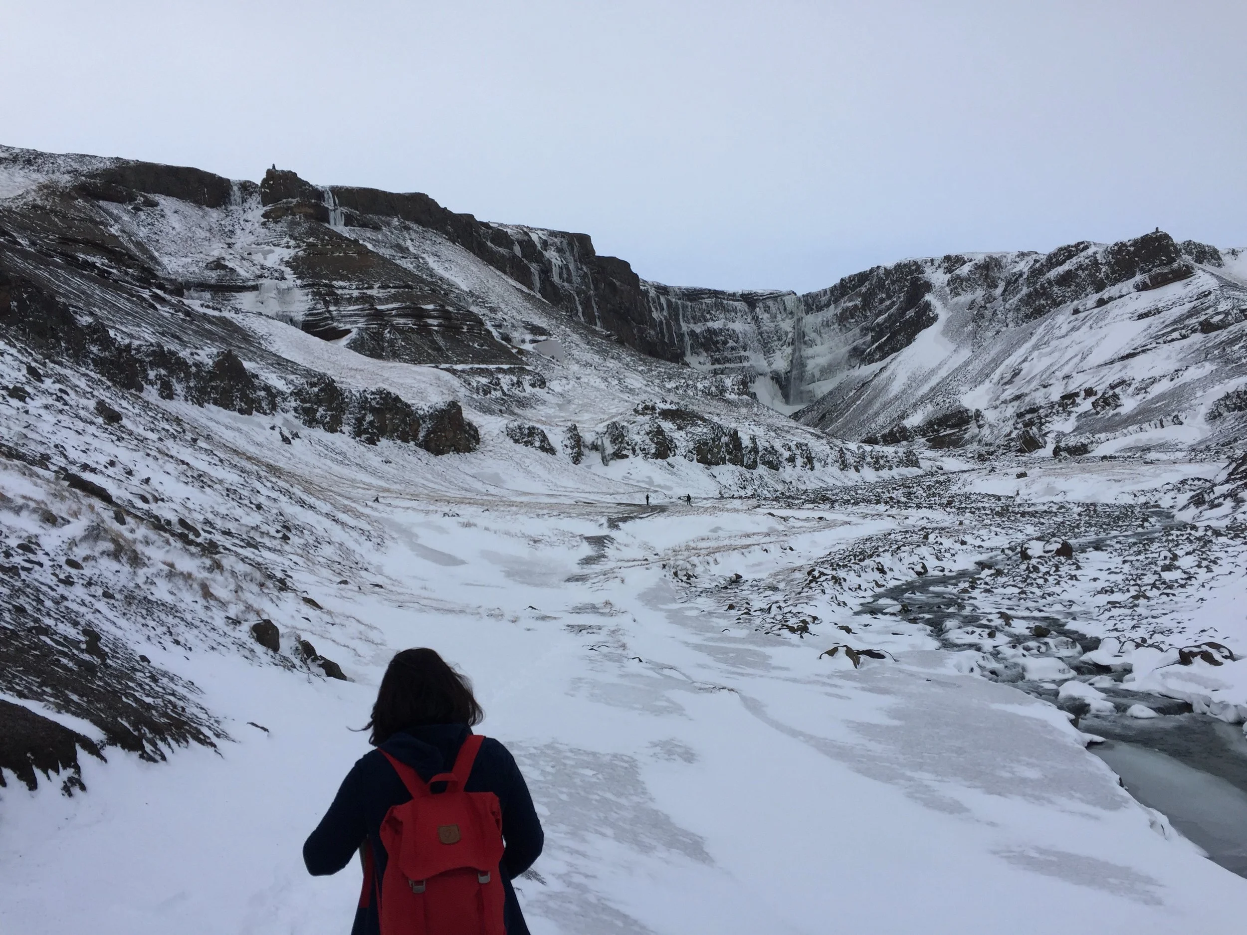 Hiking towards one of the tiers of Hengifoss waterfall.