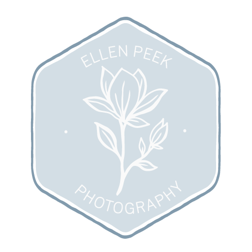 Logo for Ellen Peek Photography featuring a white outline of a flower on a light blue background within a hexagonal shape.